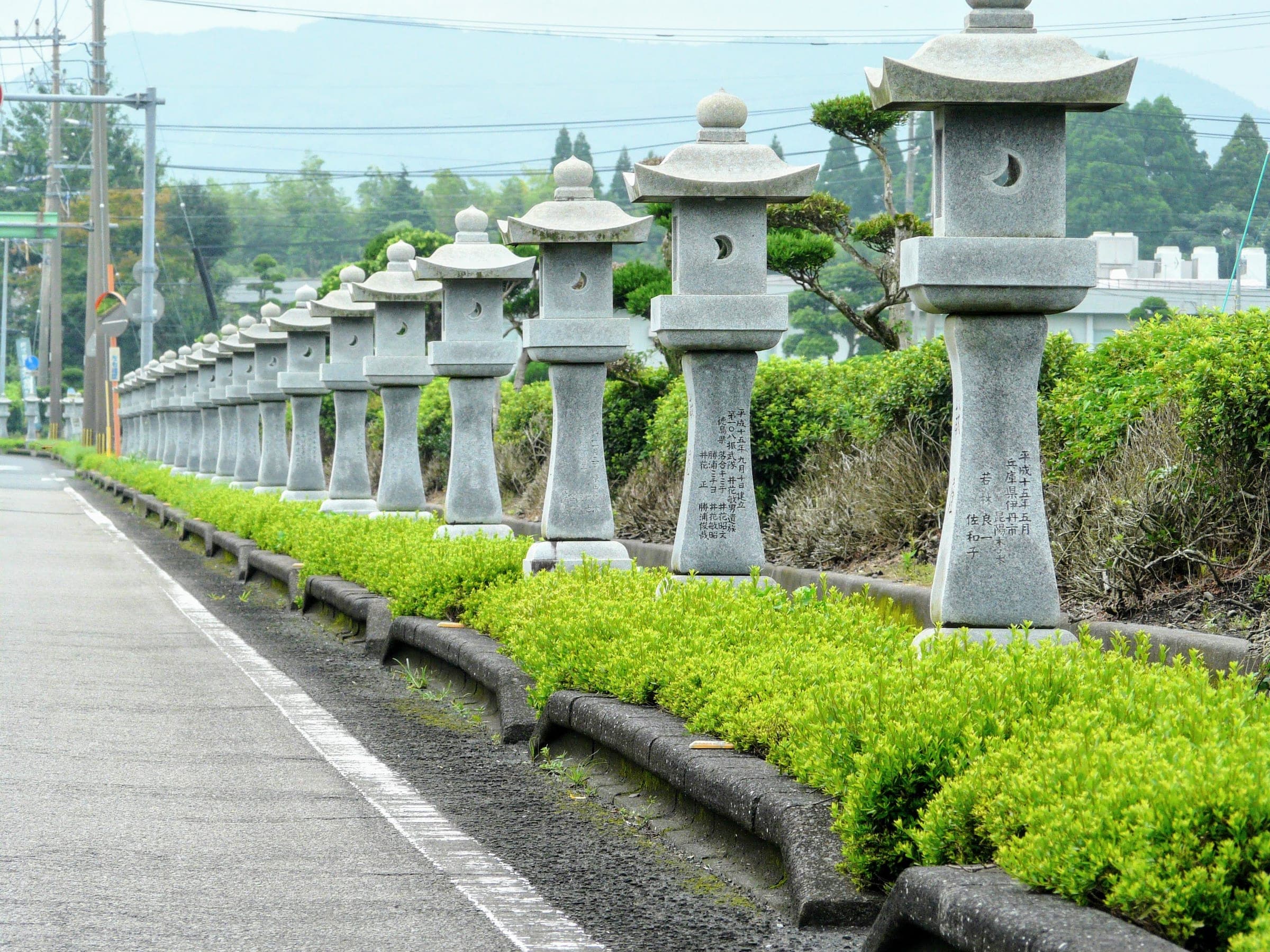 Stone lanterns placed by bereaved families line the roadside leading to the Chiran Peace Museum.