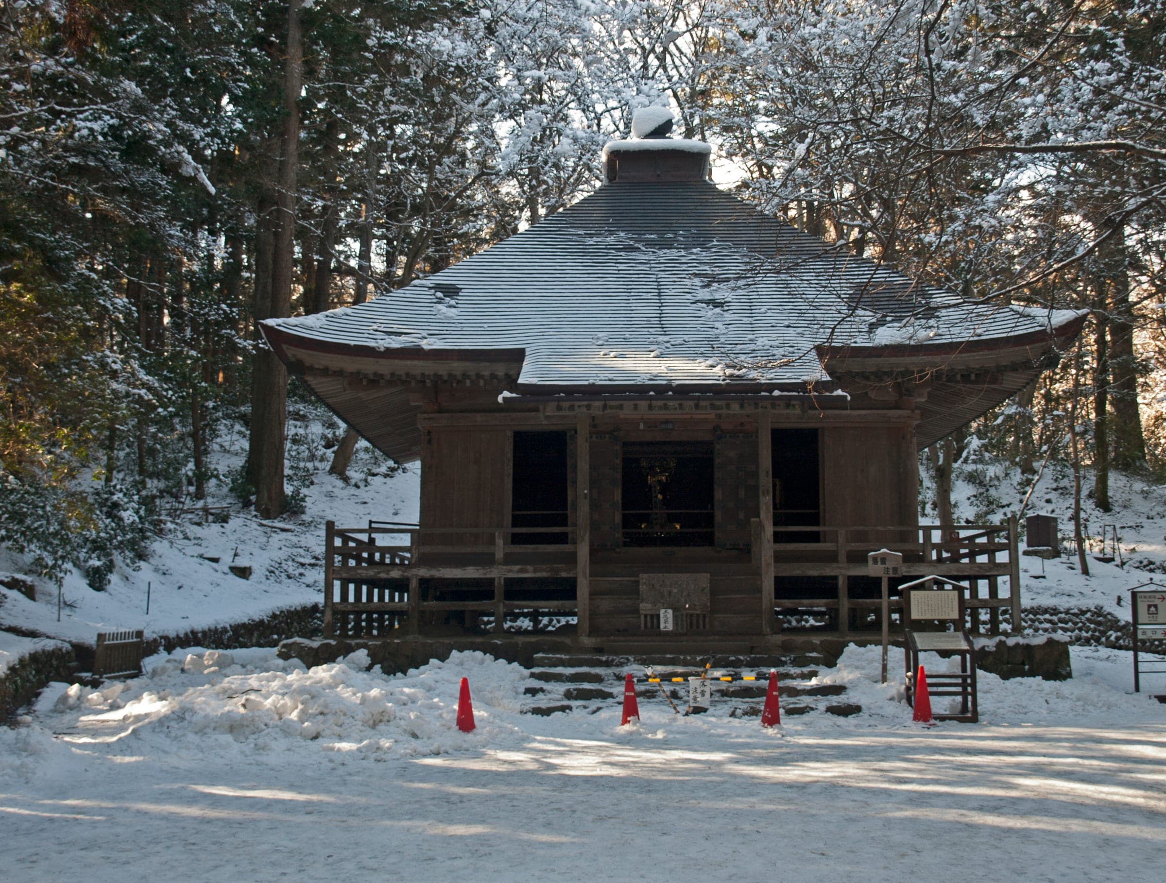 Low sun lights the snowy roof of the old sutra repository at Chuson-ji in Hiraizumi.