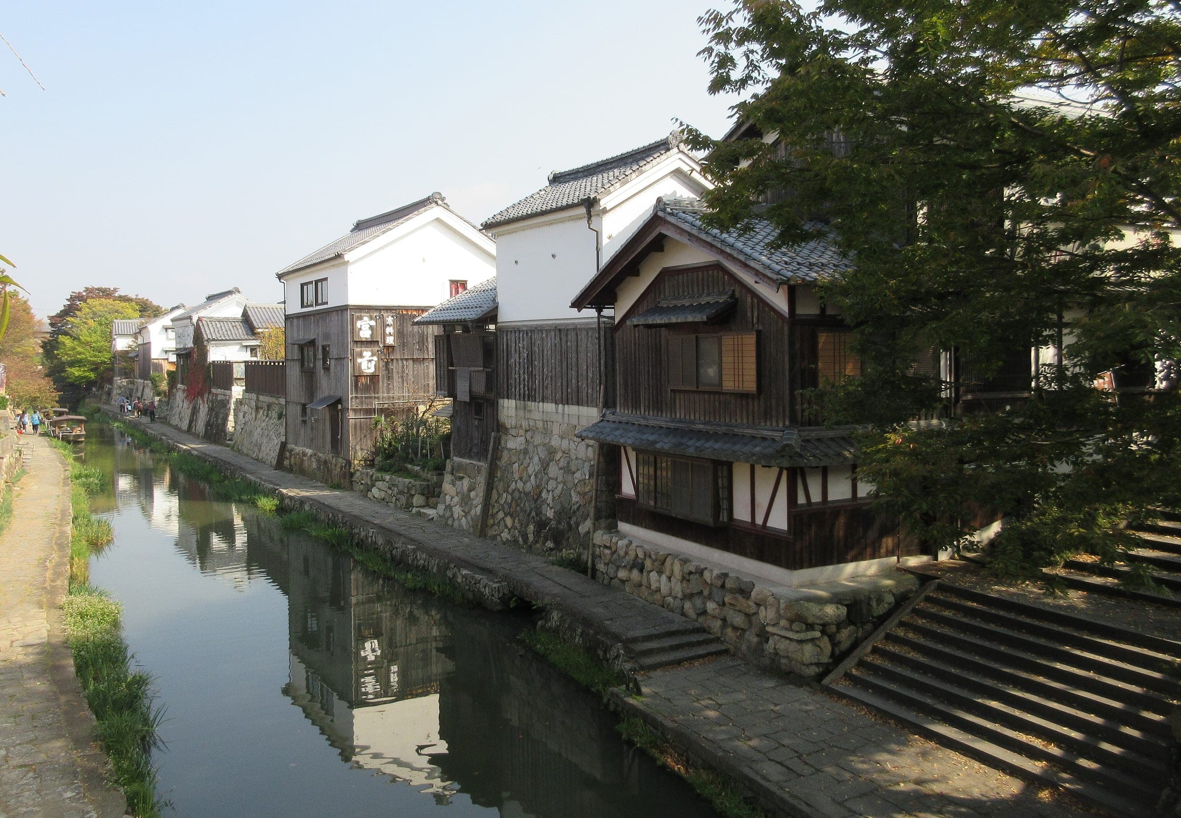 White-walled storehouses and stone steps line the Hachiman-bori Canal in Omihachiman