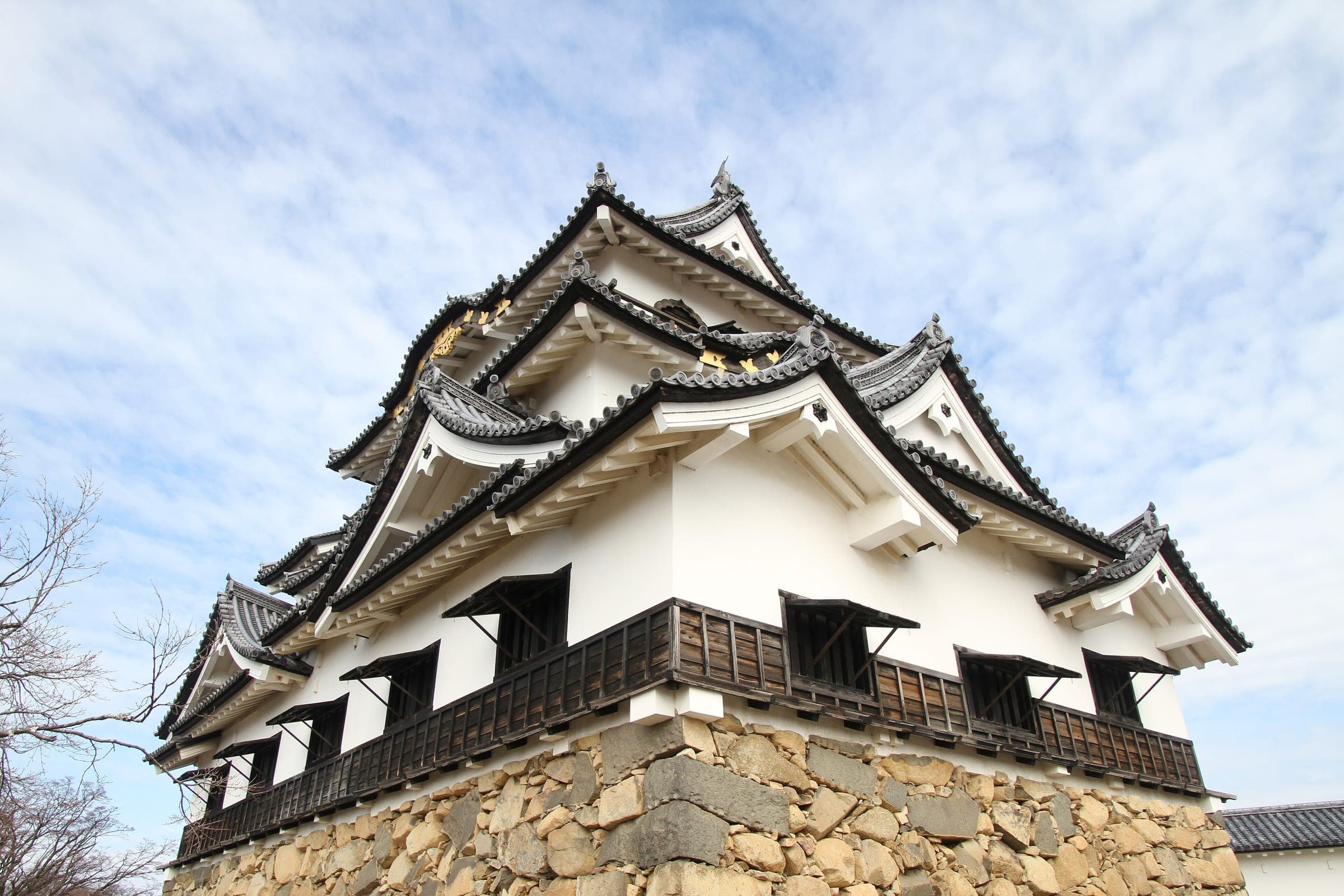 Hikone Castle's keep sits on its dry-stone base under layered gables and black-framed windows