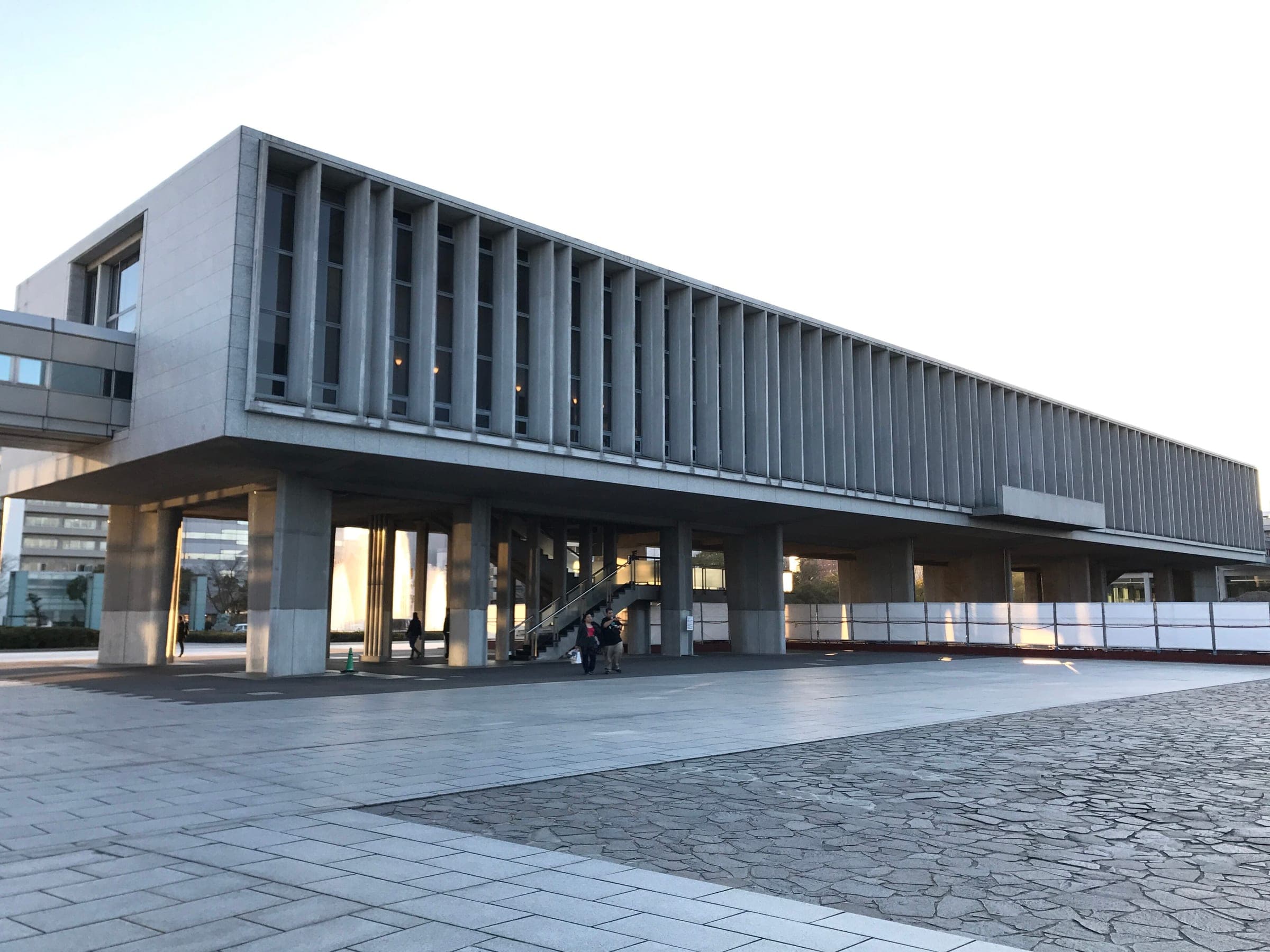 Kenzo Tange's concrete main hall of the Hiroshima Peace Memorial Museum rests on its pilotis in evening light