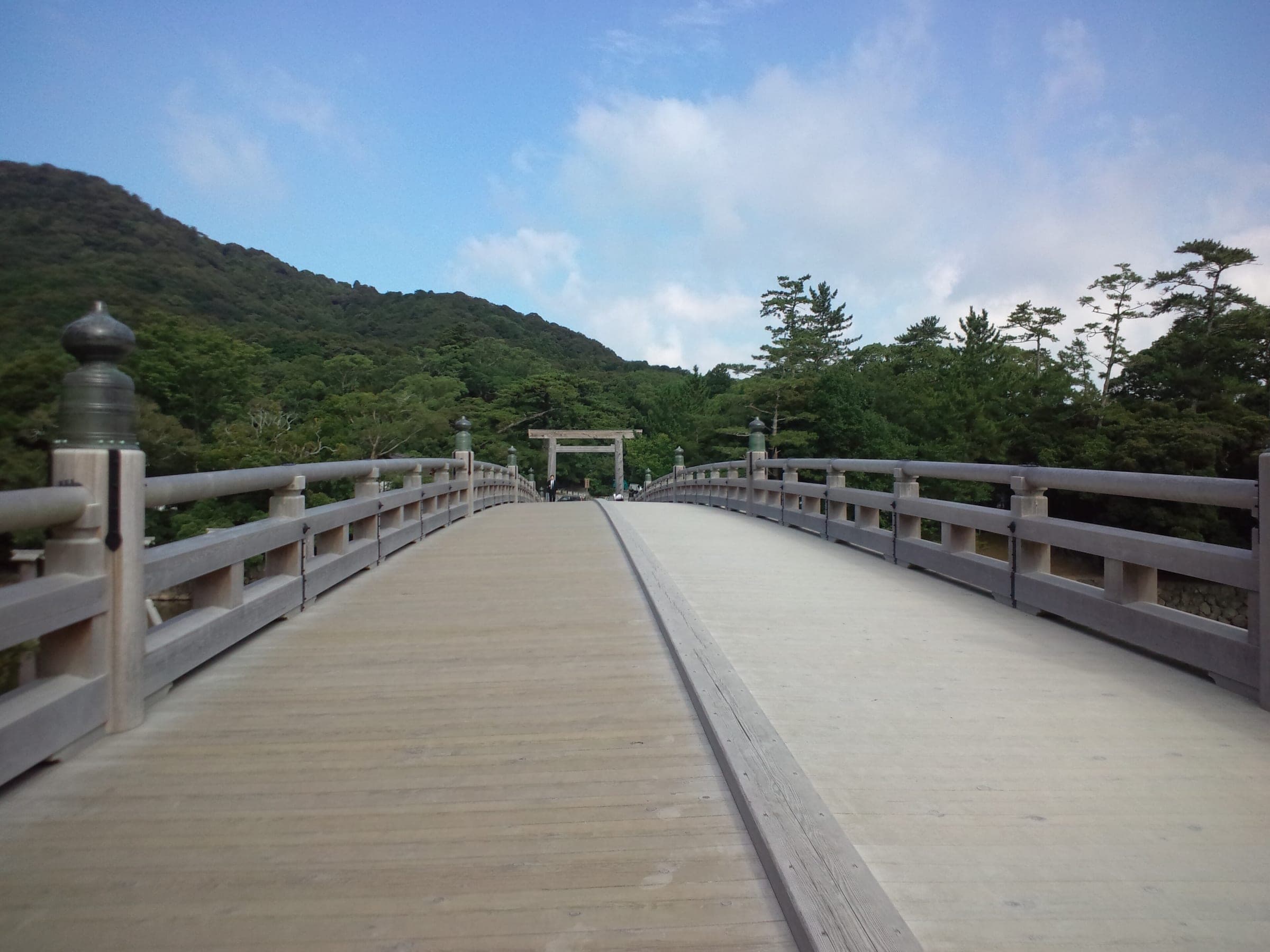 The cypress Uji Bridge leads across the Isuzu River toward the wooded grounds of Ise Jingu