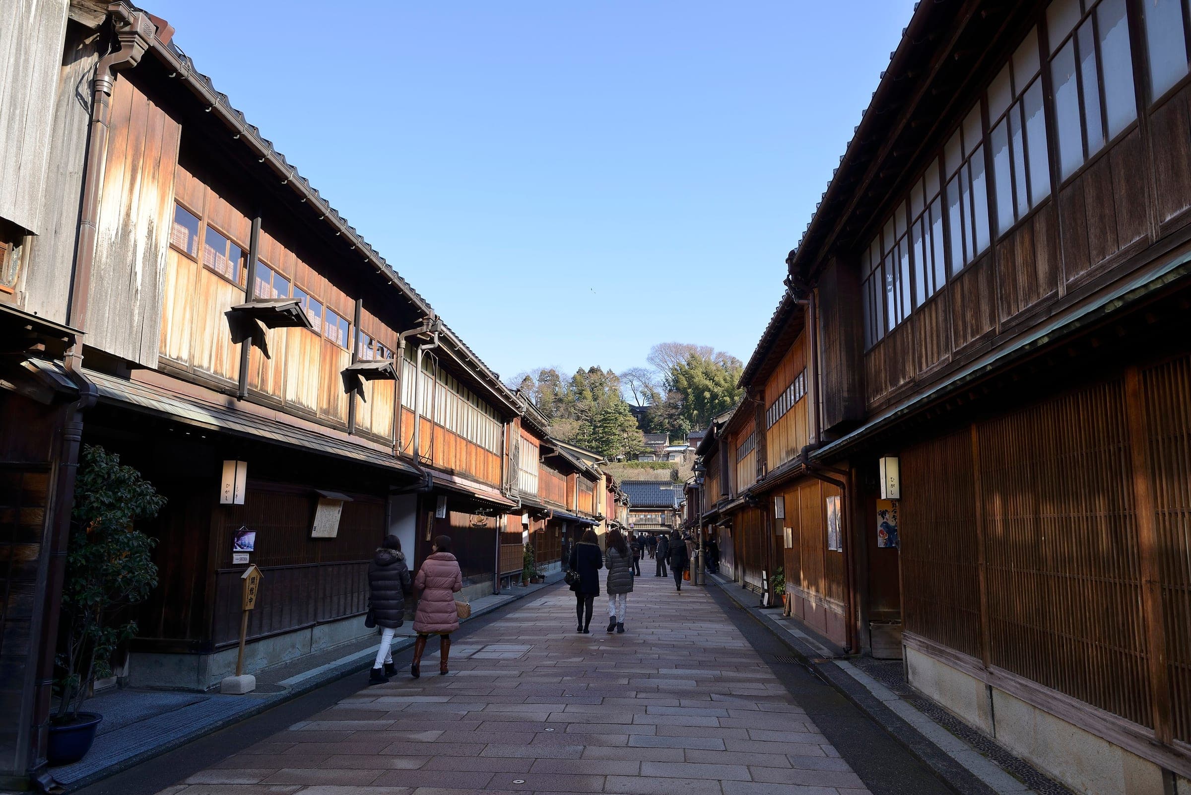Wooden teahouses with fine kimusuko lattices line the stone street of Higashi Chaya in Kanazawa in January