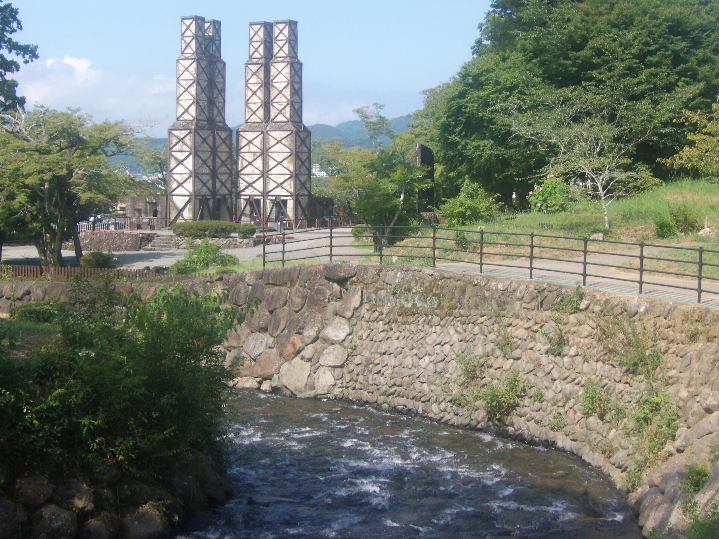 The Nirayama Reverberatory Furnace rises above the stone banks of the Nirayama Furukawa River in Izunokuni.