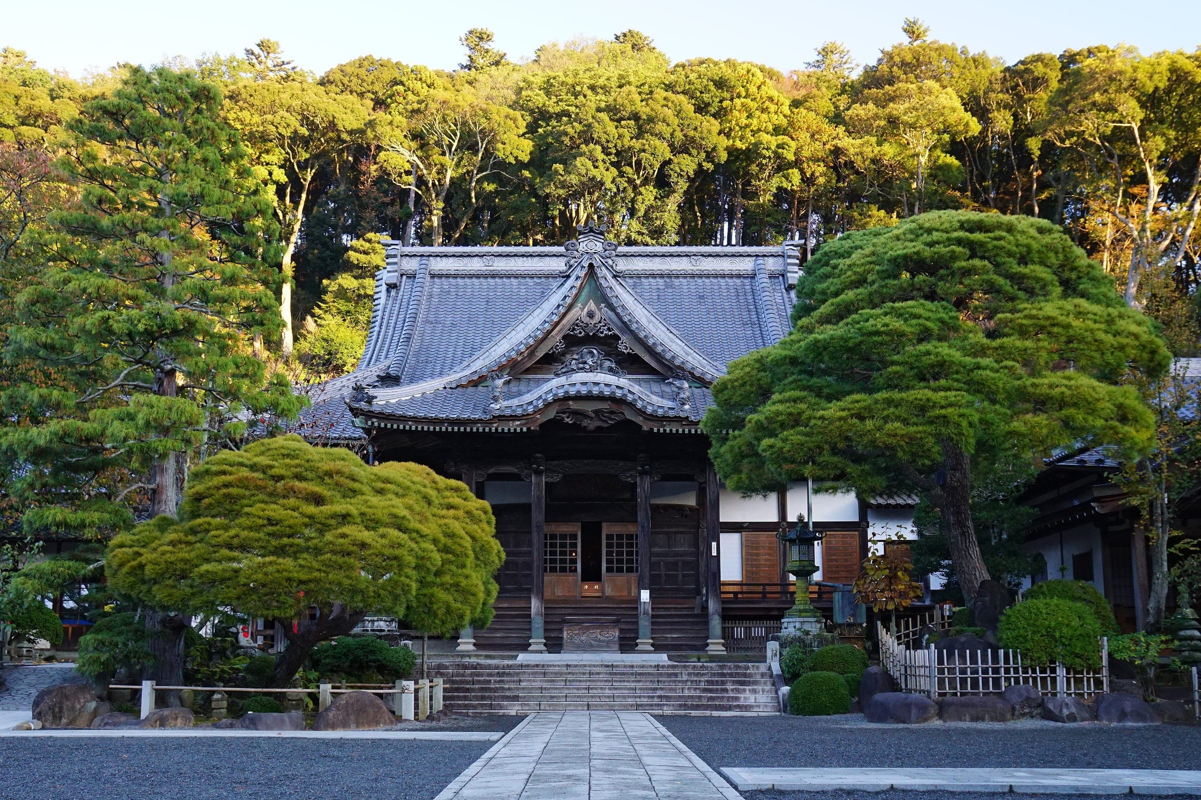 Clipped pines stand before the main hall of Shuzen-ji temple in Shuzenji.
