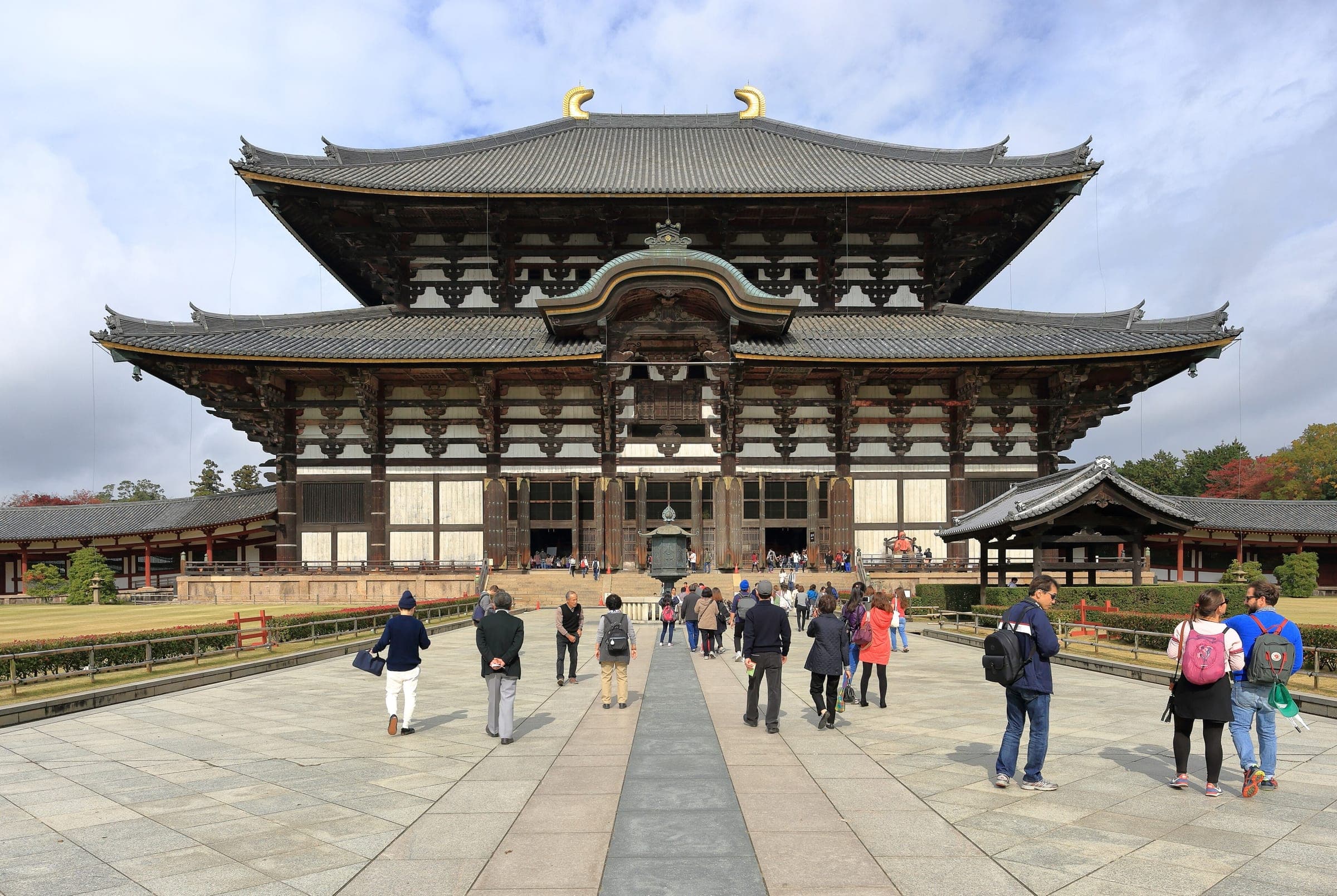 Visitors walk the stone path toward the Great Buddha Hall of Todai-ji in Nara