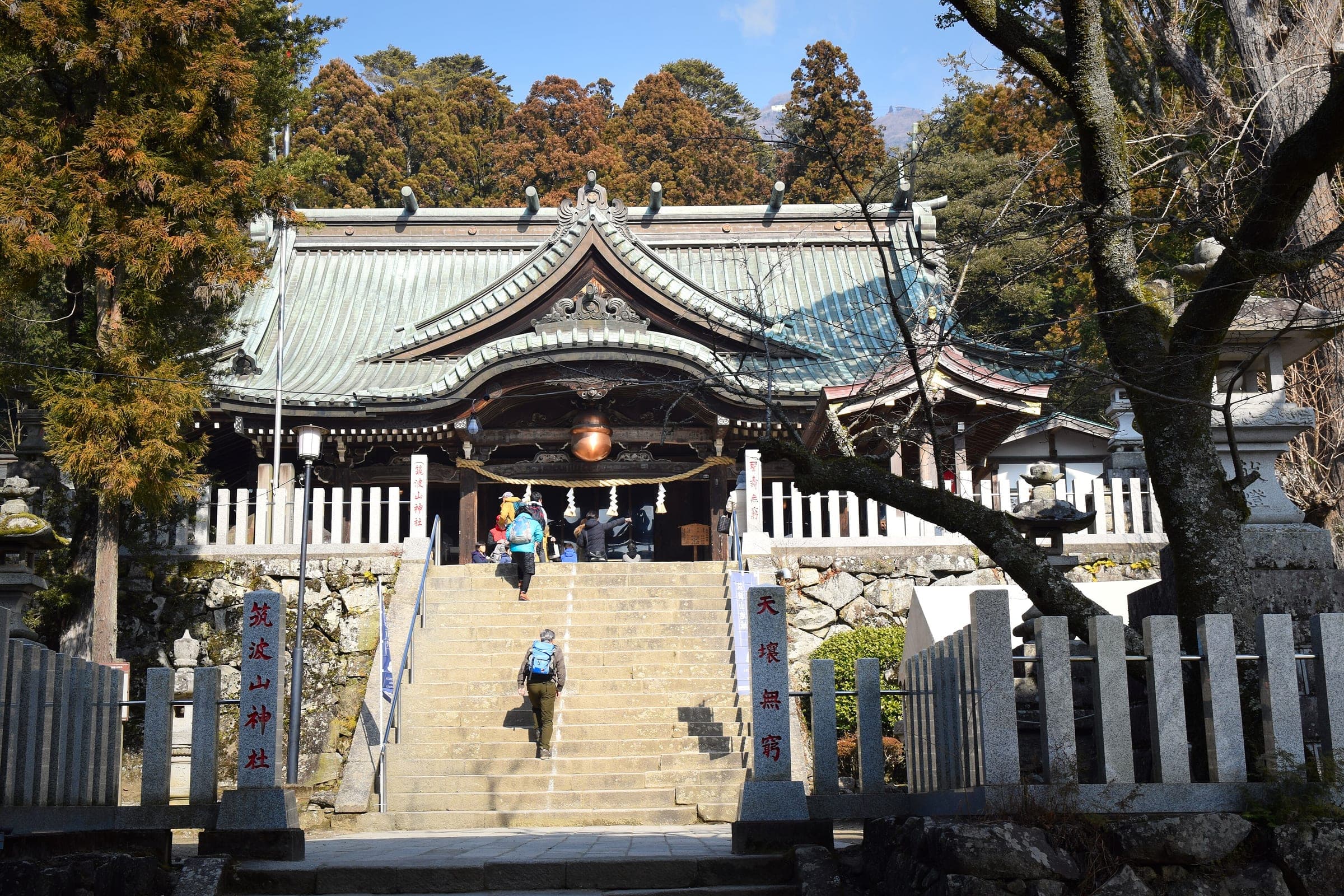 Stone steps climb between granite posts to the worship hall of Mt. Tsukuba Shrine.