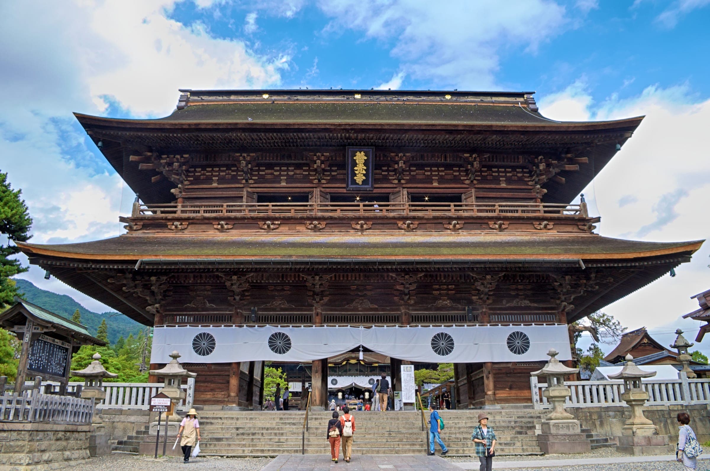 The two-storey Sanmon gate of Zenko-ji stands at the top of its stone steps in Nagano City.