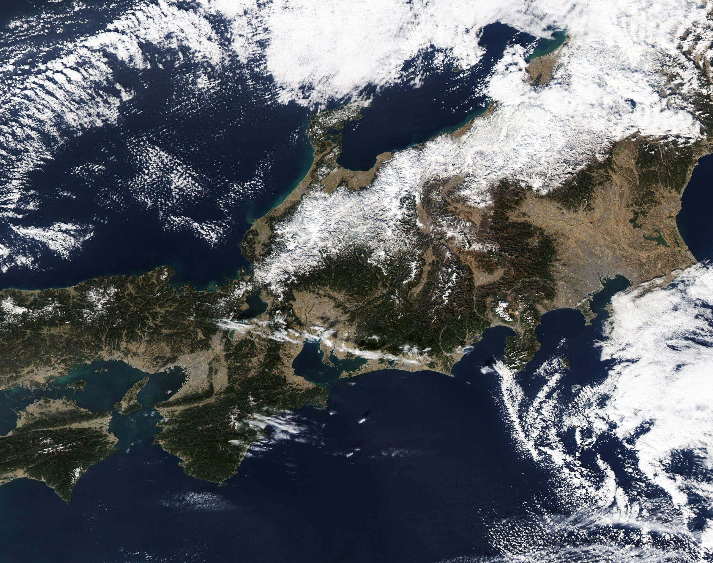 A January satellite view shows snow on central Honshu's Sea of Japan side and cloud streets over the sea
