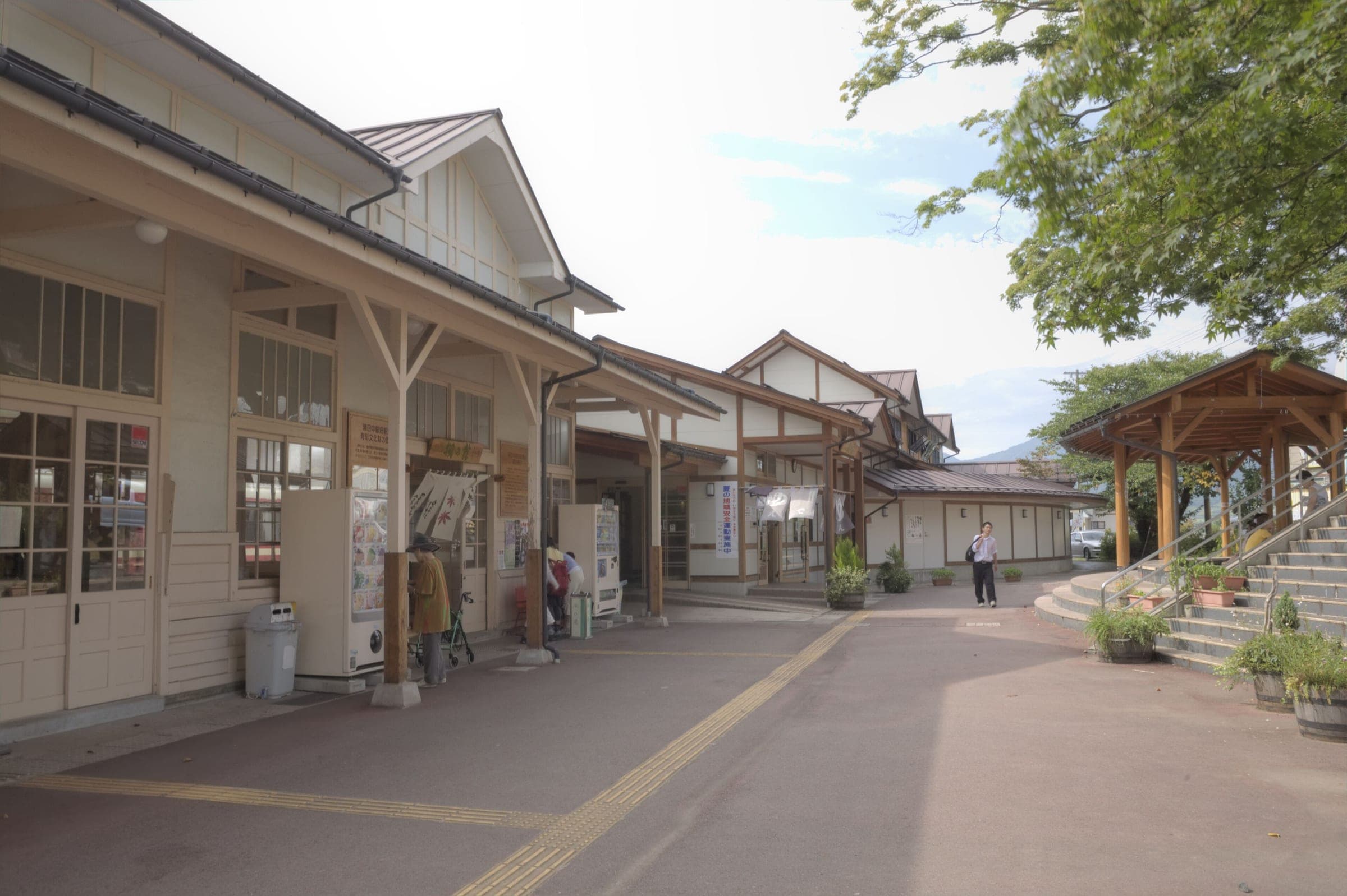 The old wooden Yudanaka station building lines the walk to the Kaede no Yu day bath next door.
