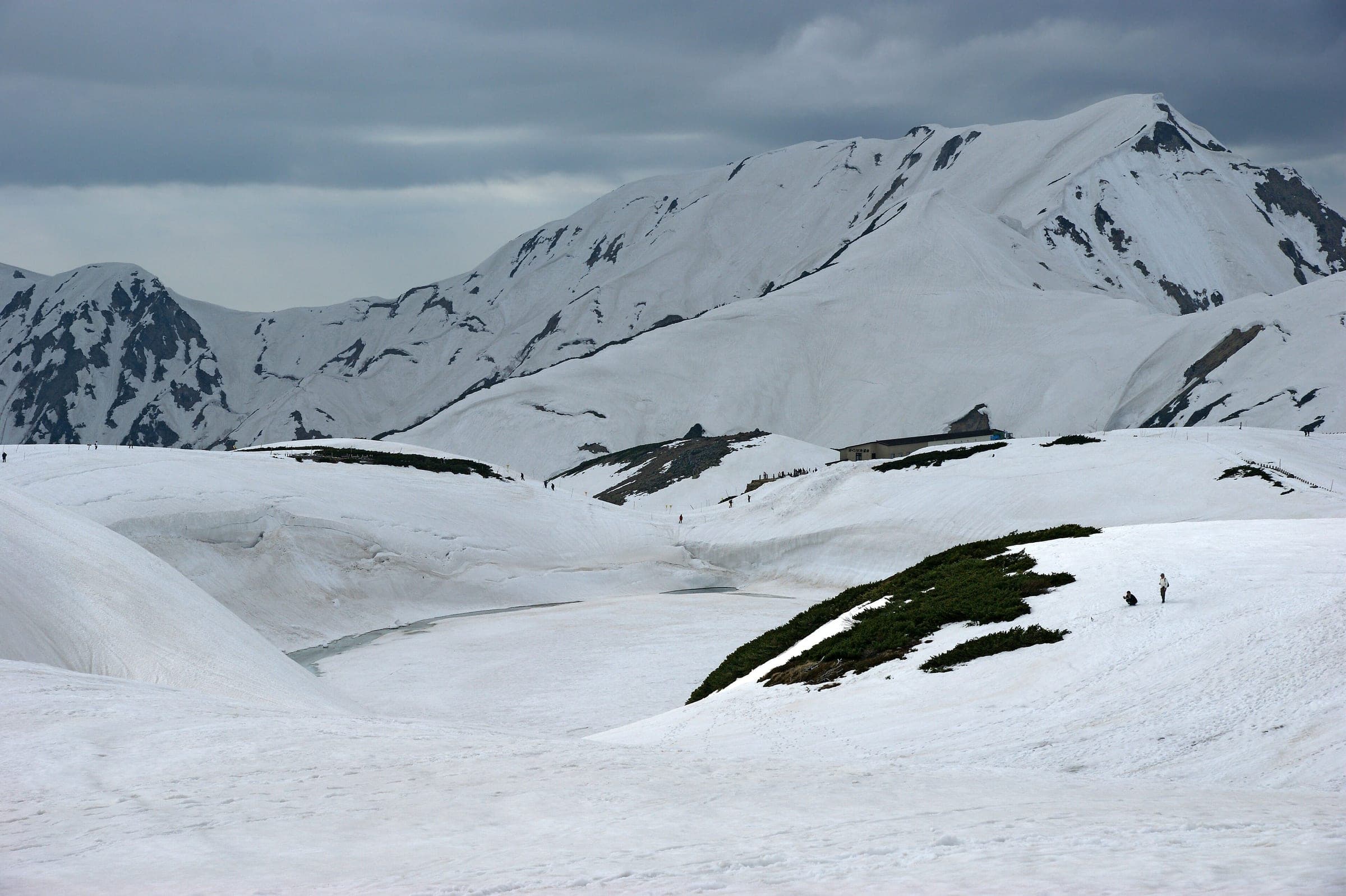 Snow still covers Mikurigaike pond and the slopes around it below the Tateyama peaks in May