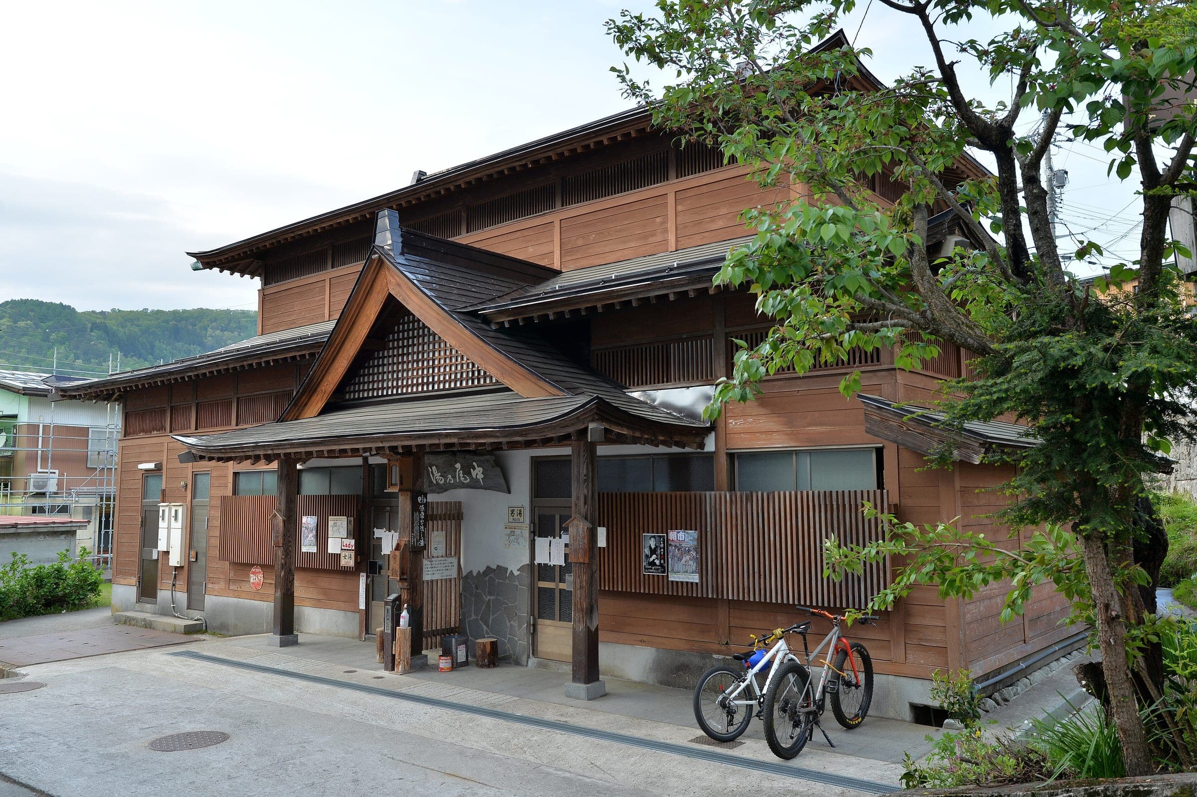Nakao-no-Yu is a timber public bathhouse with a tall gabled roof in Nozawa Onsen.