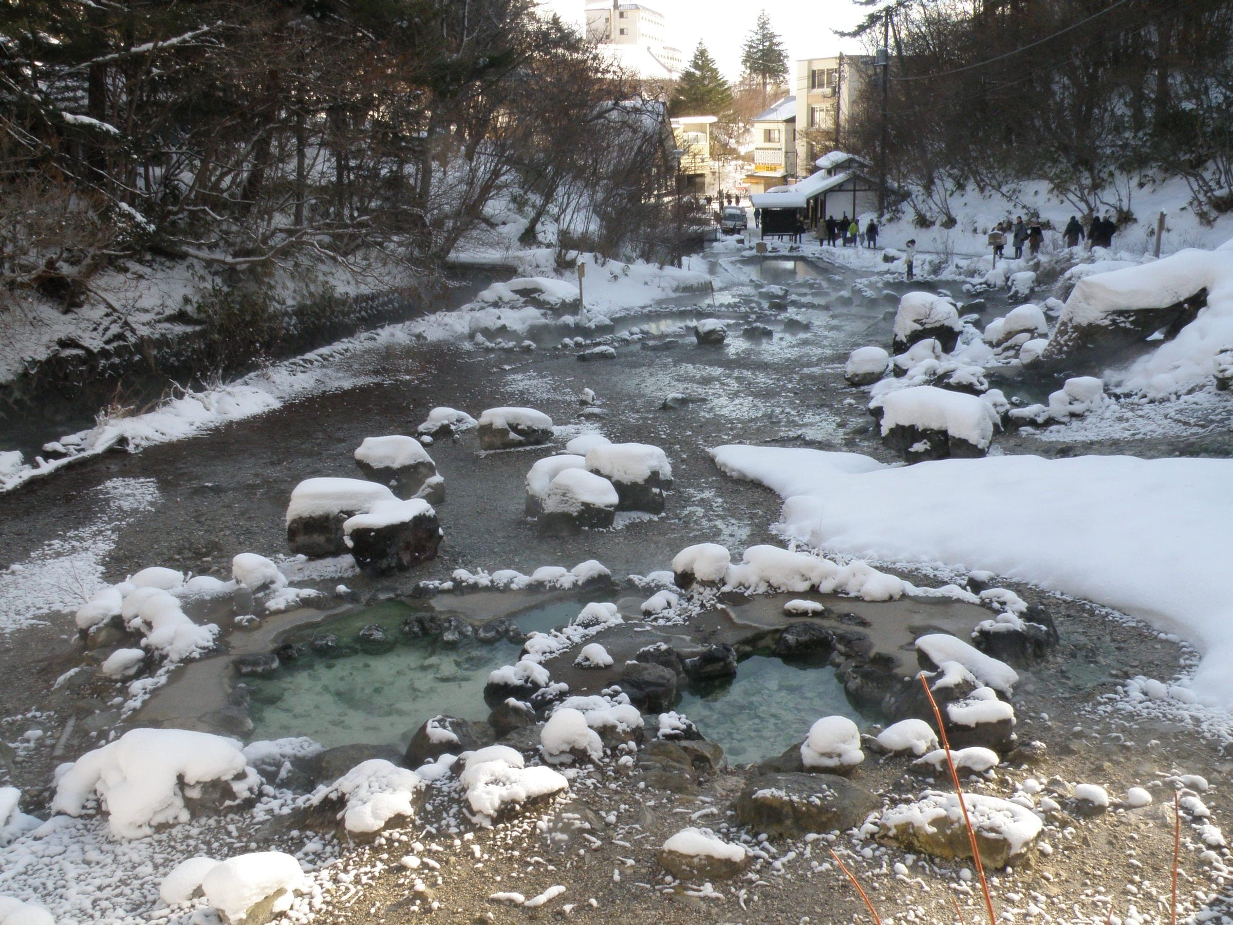 Snow-capped rocks ring the warm pools of Sai-no-kawara Park on the way to the Kusatsu open-air bath