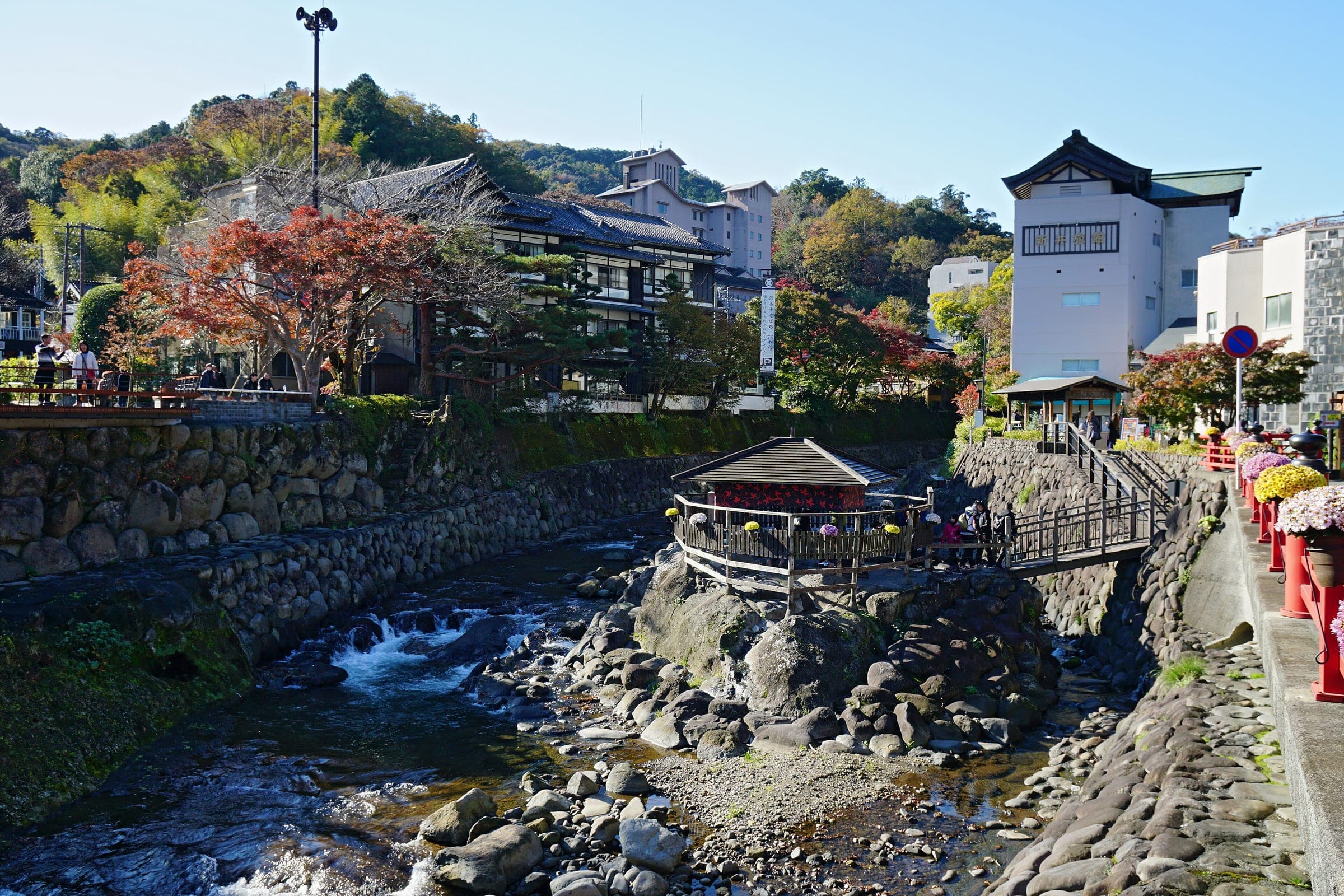 The Tokko-no-yu pavilion sits on rocks in the Katsura River at Shuzenji Onsen below the Hako-yu tower.