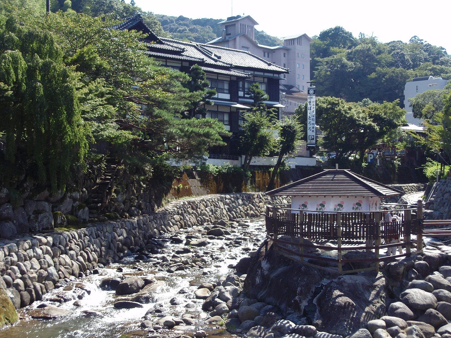 Tokko-no-yu's wooden pavilion stands over the hot spring on the rocks of the Katsura River in Shuzenji.