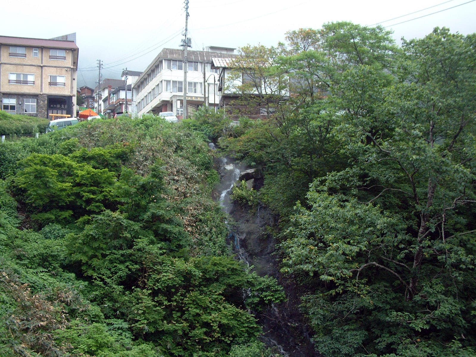 Inns at Tsubame Onsen perch above a green ravine where spring water spills down the rock