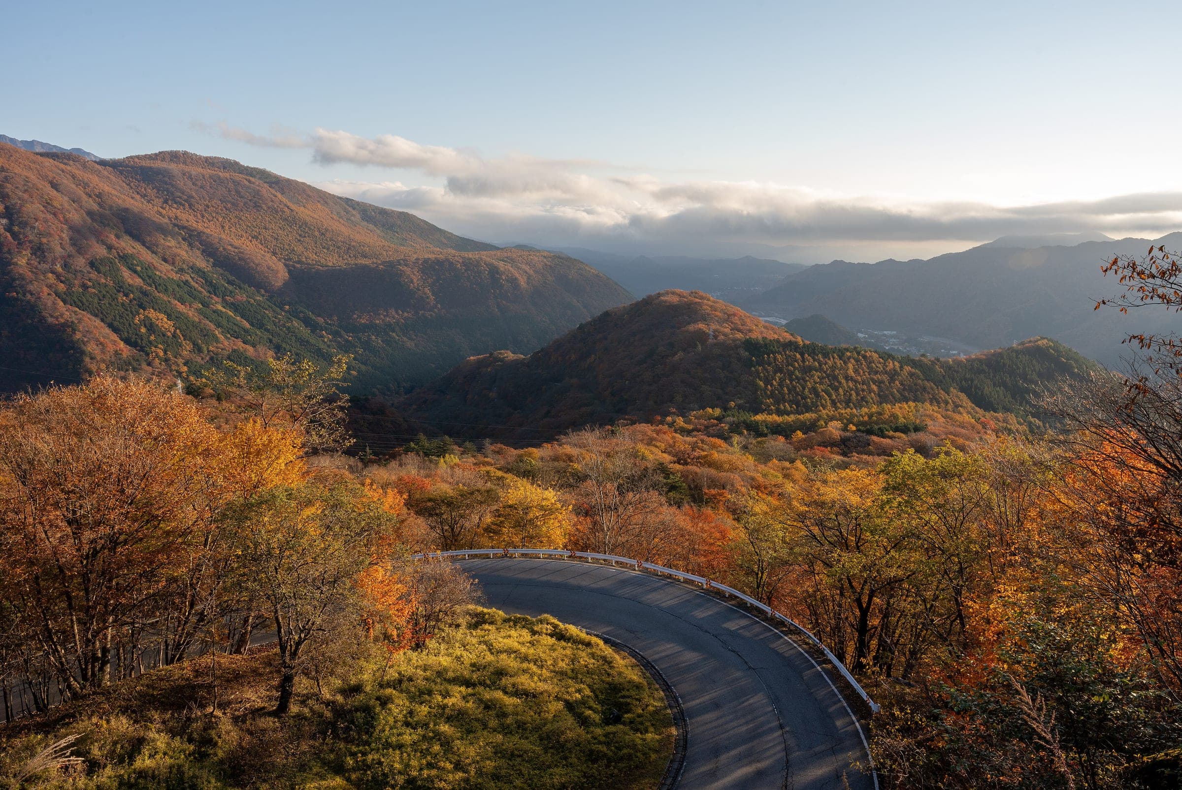 The Irohazaka road curves through orange November forest on the climb from Nikko to Lake Chuzenji