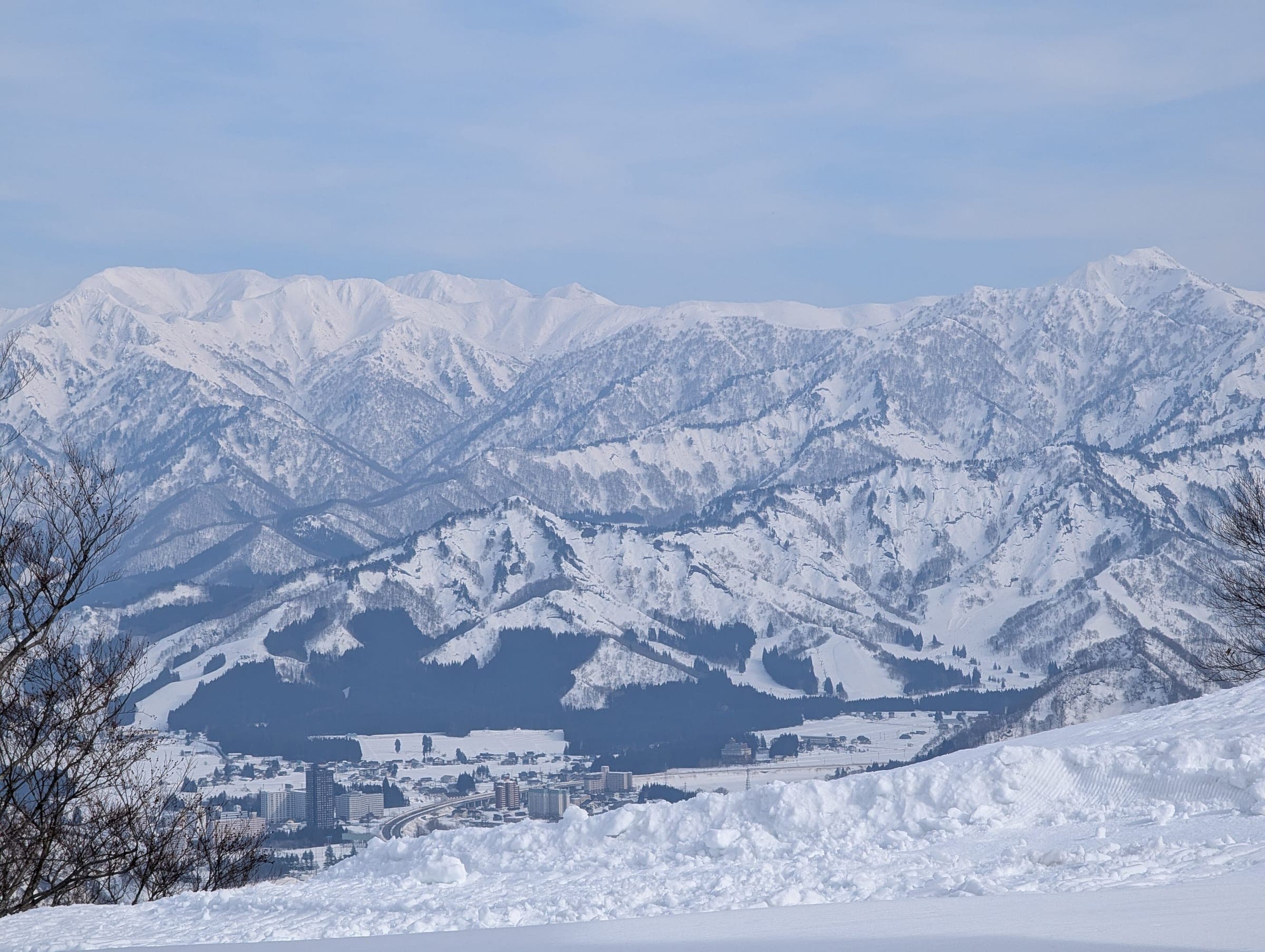 Snowbound peaks fill the skyline across the Uonuma valley from the slopes of GALA Yuzawa