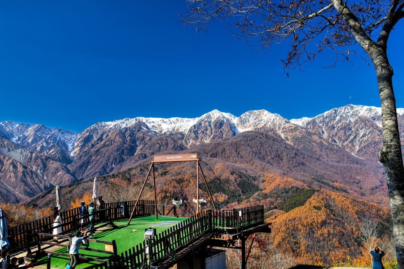 Visitors gather on the summit terrace of Hakuba Iwatake facing the first snow on the Hakuba range in November