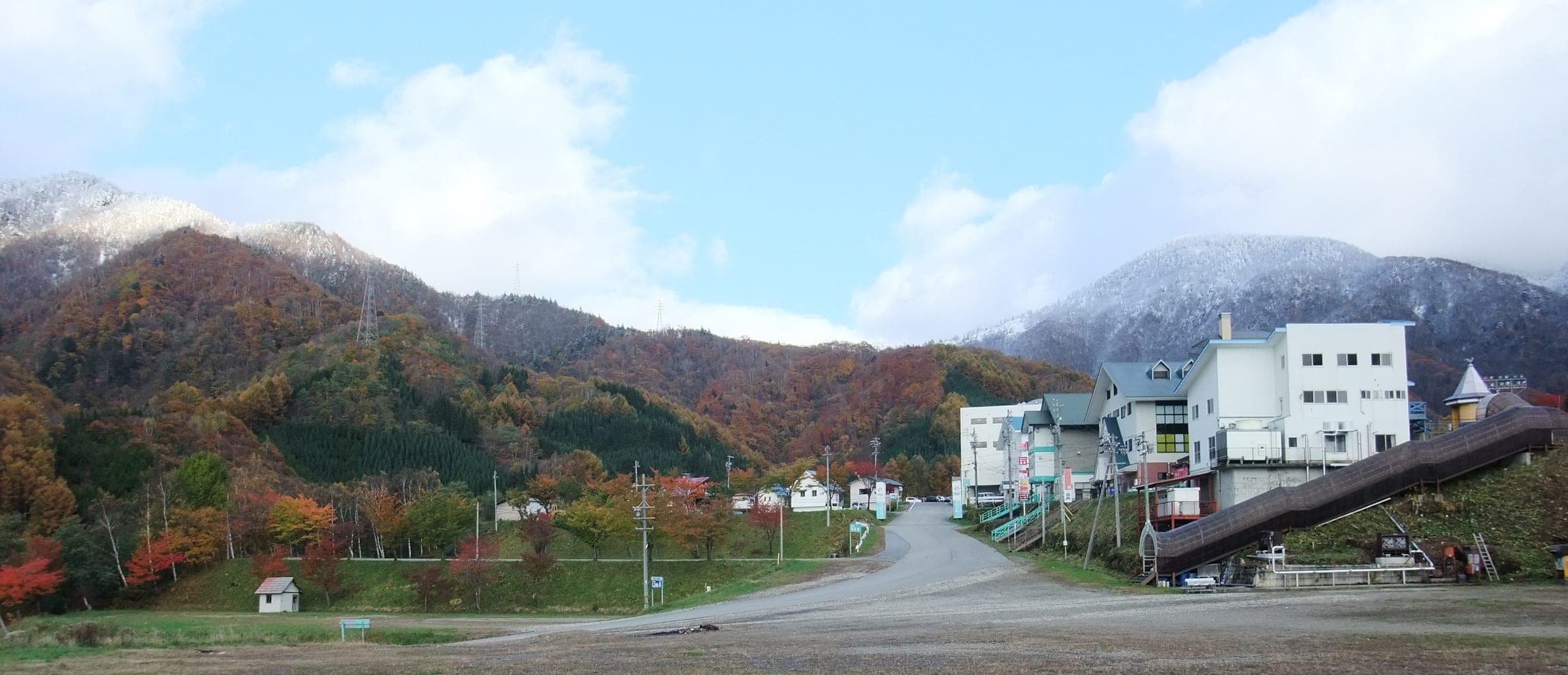 The base lodges of Hida Honokidaira sit below autumn slopes as the first snow dusts the peaks