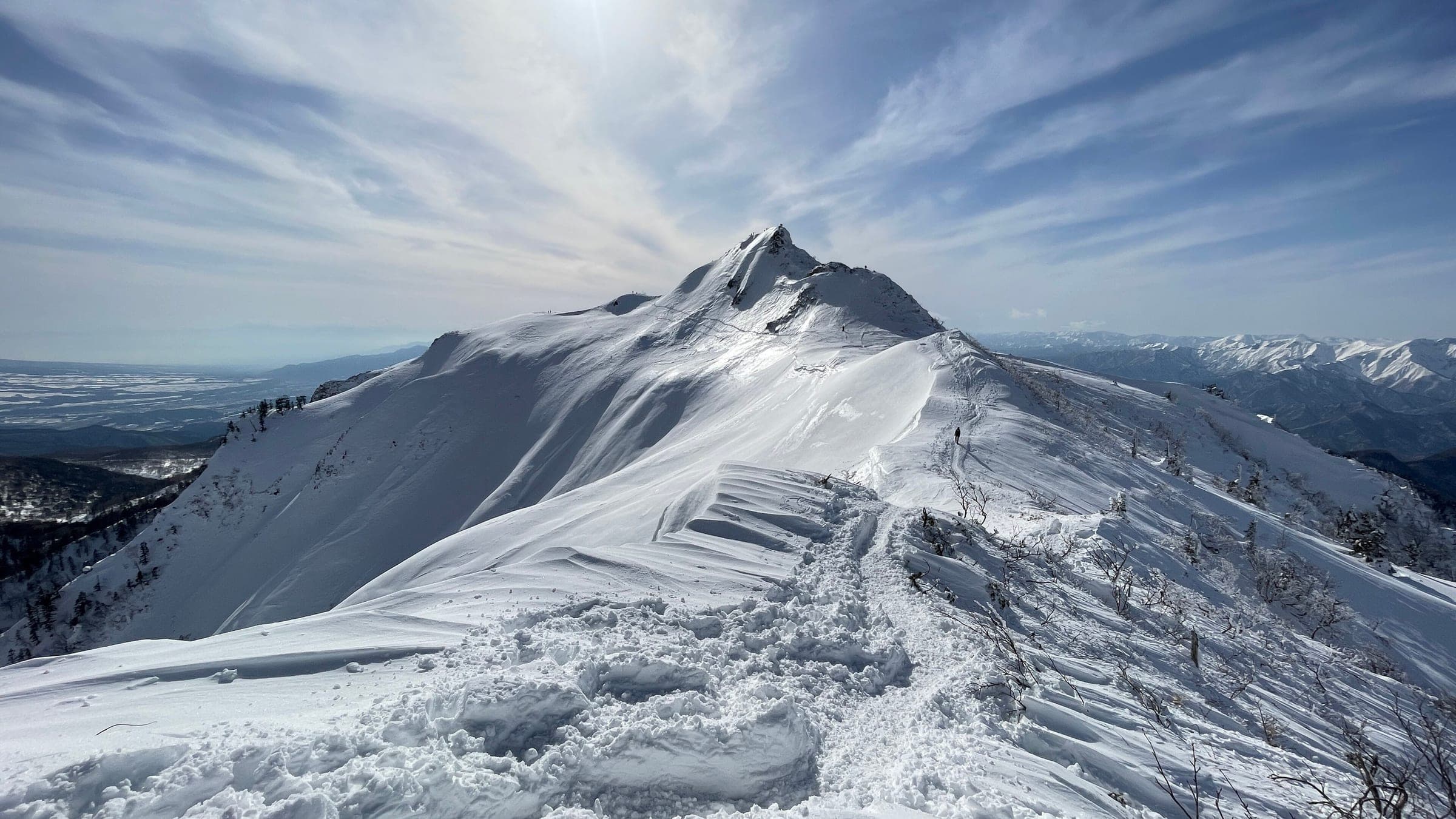 Wind-carved snow lines the ridge to Kengamine on Mount Hotaka above Kawaba