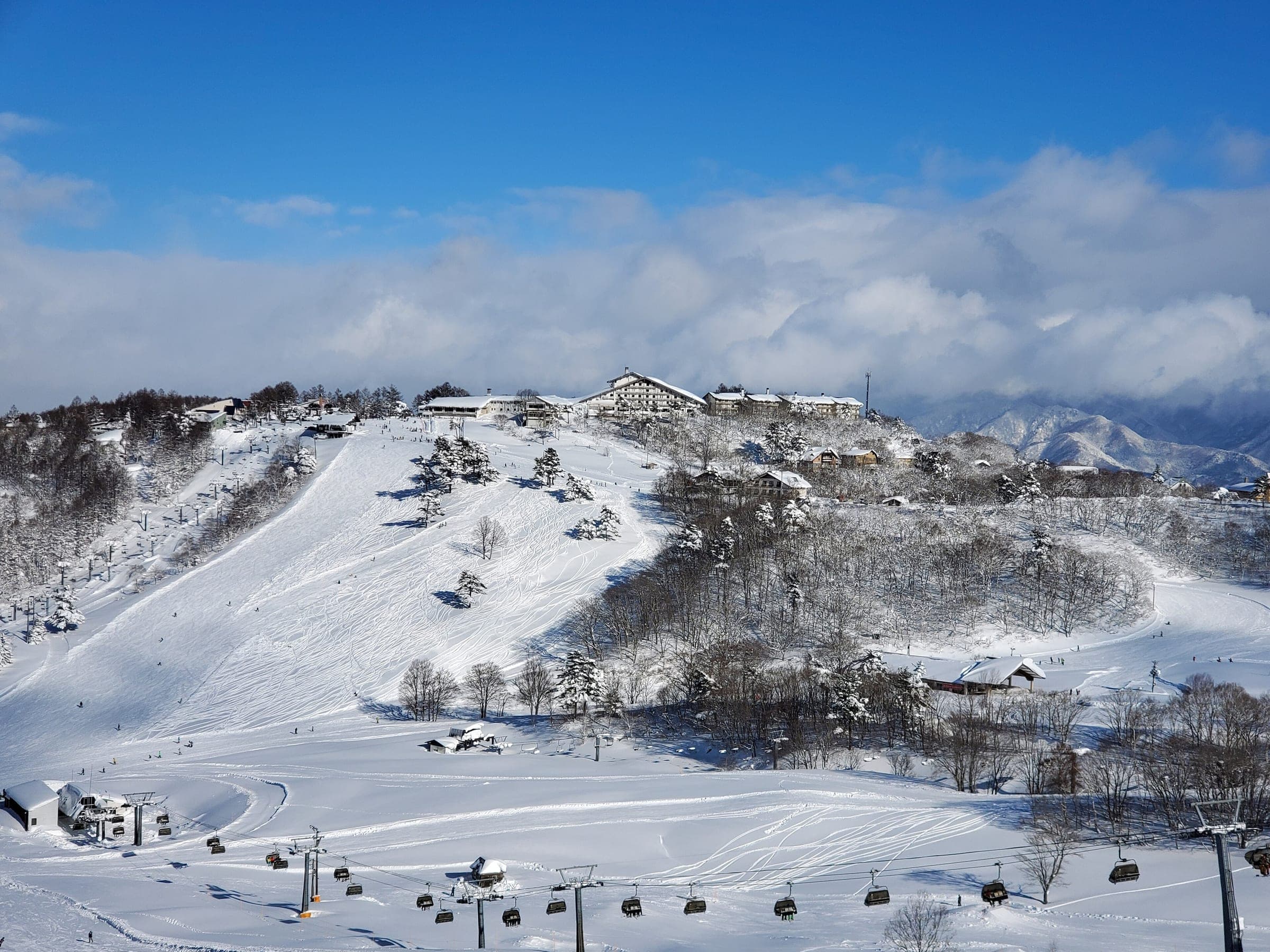 Chairlifts cross the lower slopes of Madarao below the hotels of Madarao Kogen on a fresh snow day