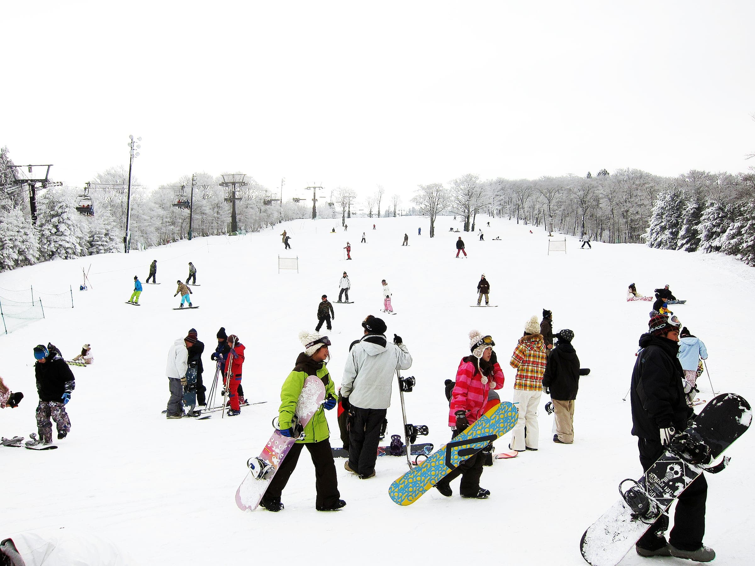 Snowboarders and skiers gather on the beginner slope at Mizuho Highland in early January