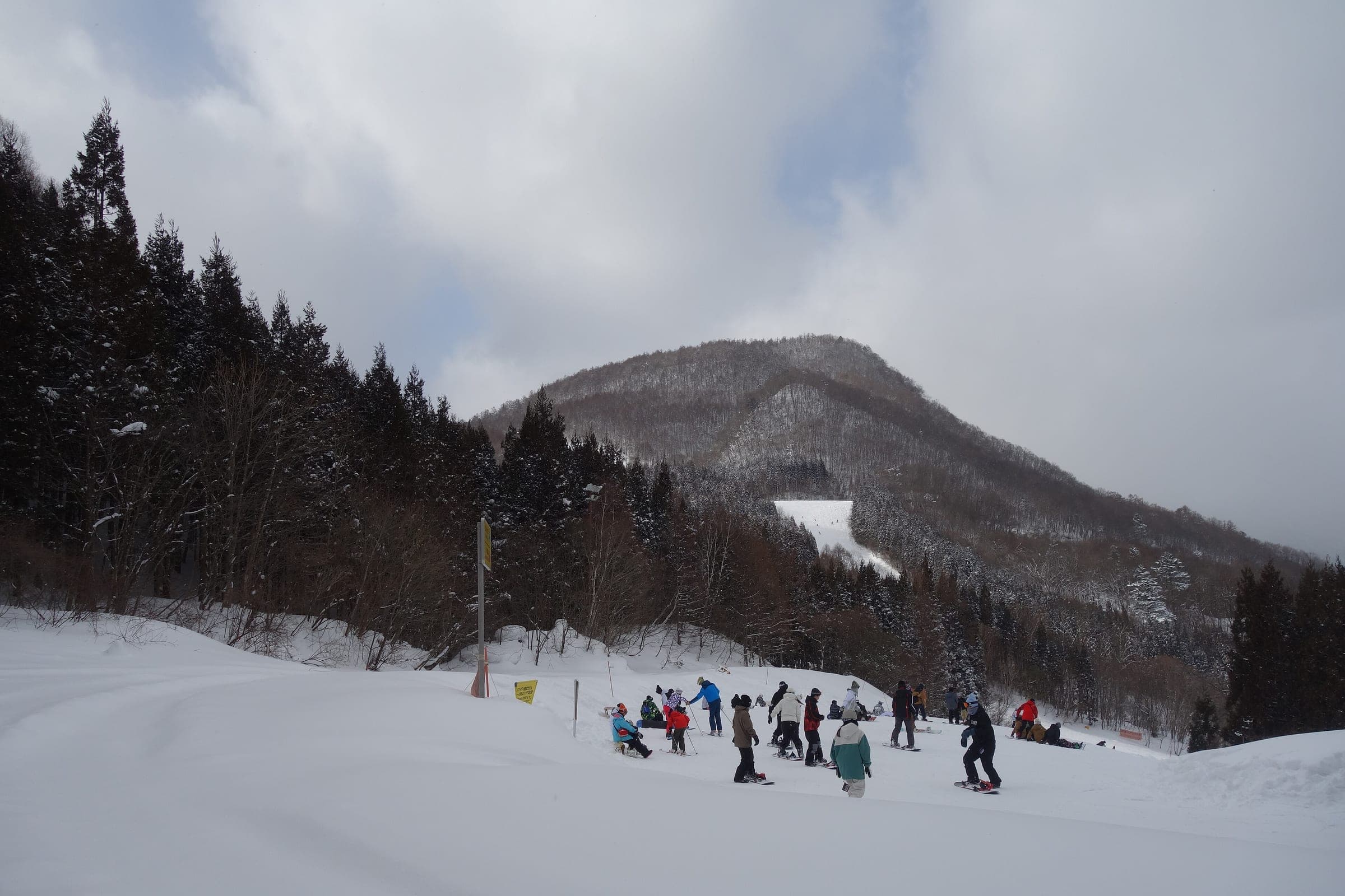 Snowboarders gather on the upper slopes at Norn Minakami below Mount Azumaya