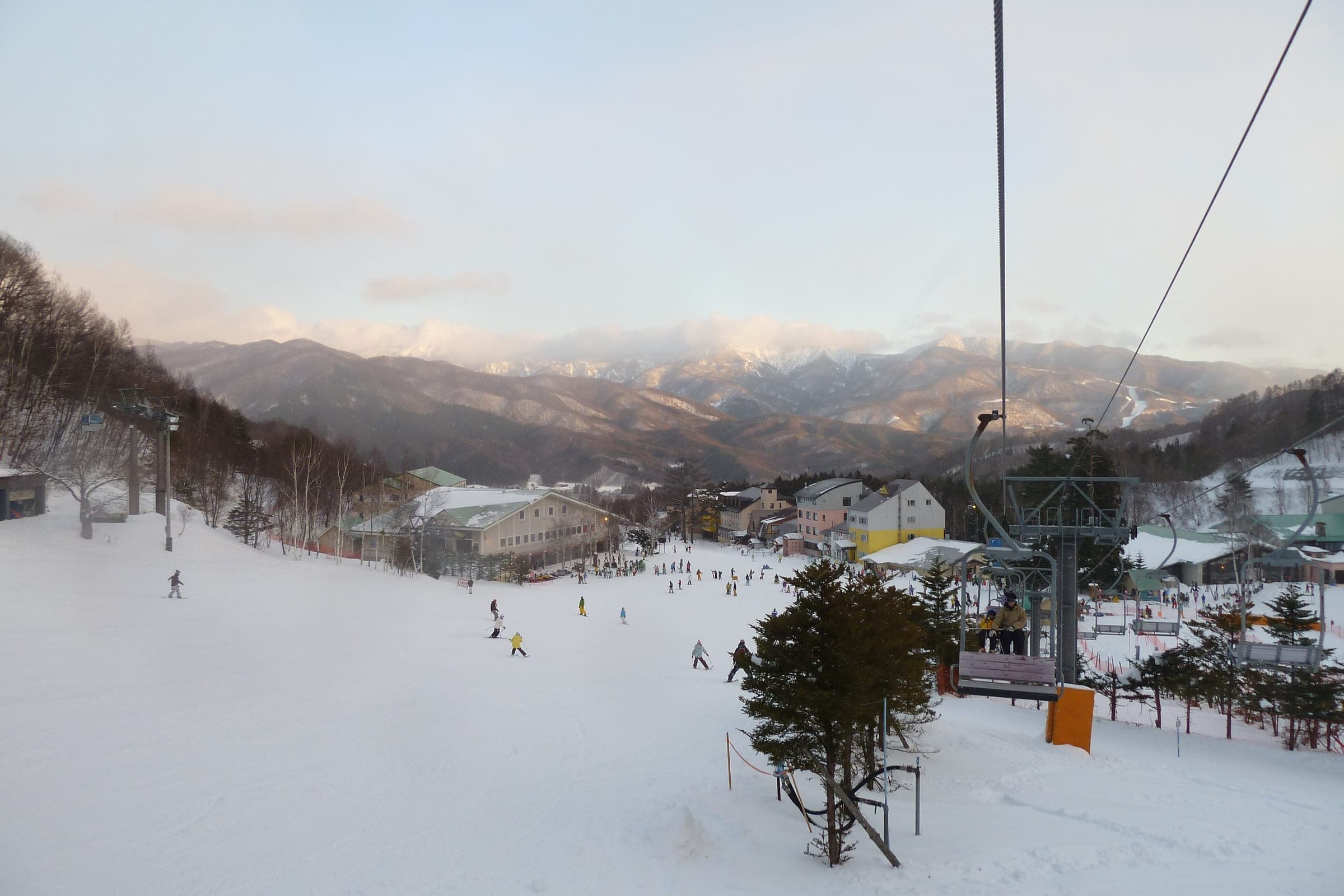Late light falls on the Romance lift and the base lodges at Oze Iwakura in January