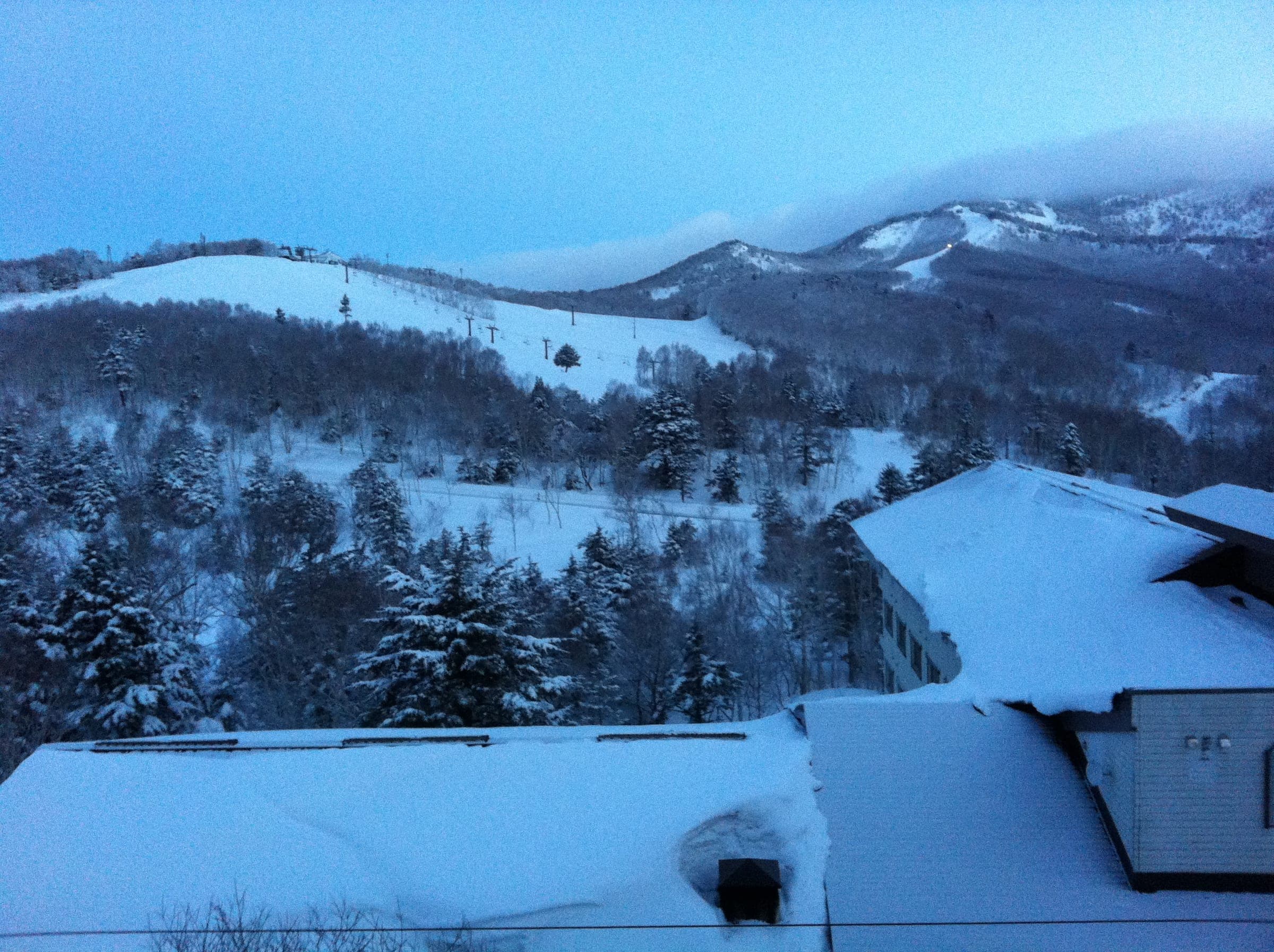 Fresh snow covers the roofs and slopes at Shiga Kogen Ichinose Diamond in the blue hour