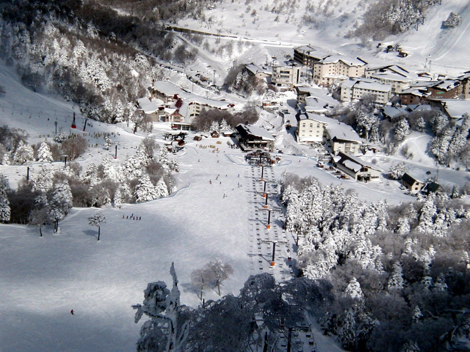 A chairlift drops toward the snowbound hotels of Kumanoyu at the foot of its ski slope