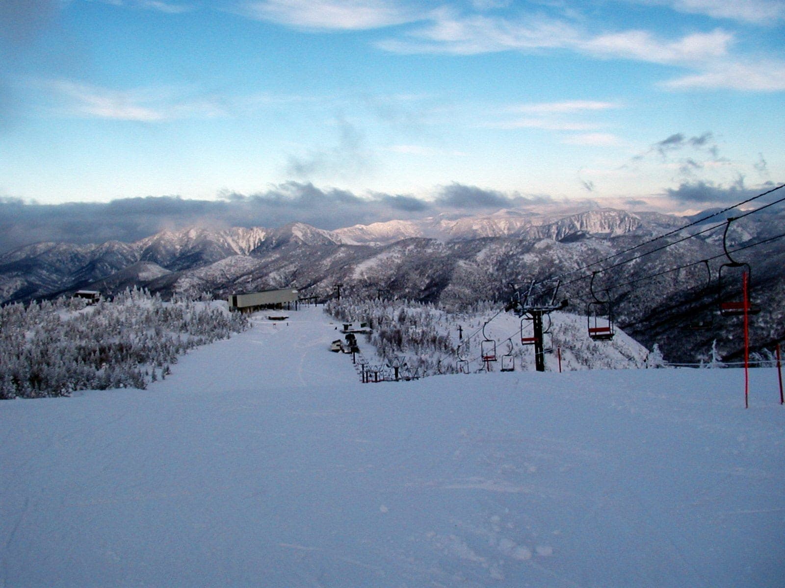A run near the top of Mount Yakebitai looks northwest toward the Okushiga Kogen slopes and frosted ridges