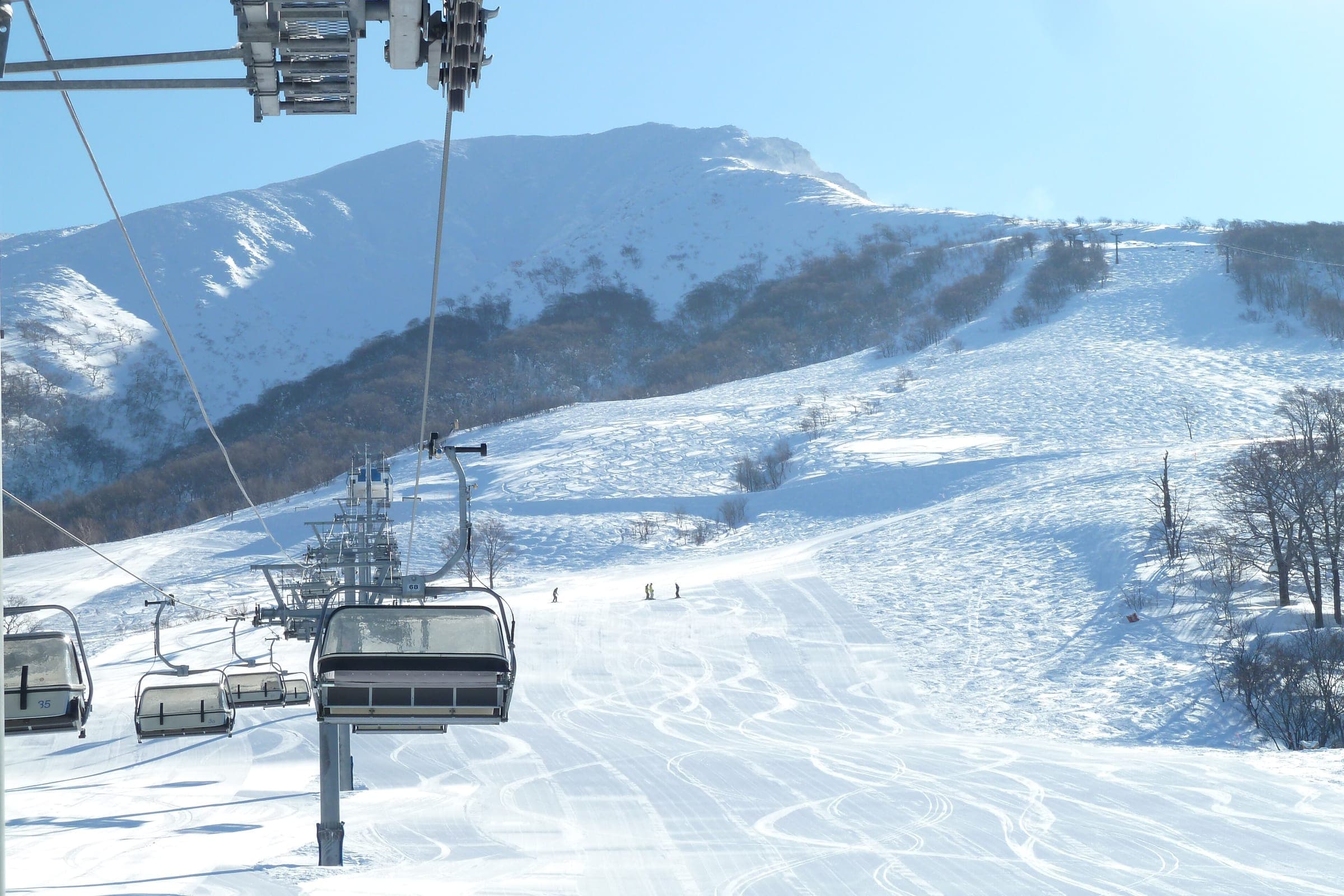 The Kamoshika quad climbs toward Odake, the high summit of Mount Akita-Komagatake, at Tazawako.