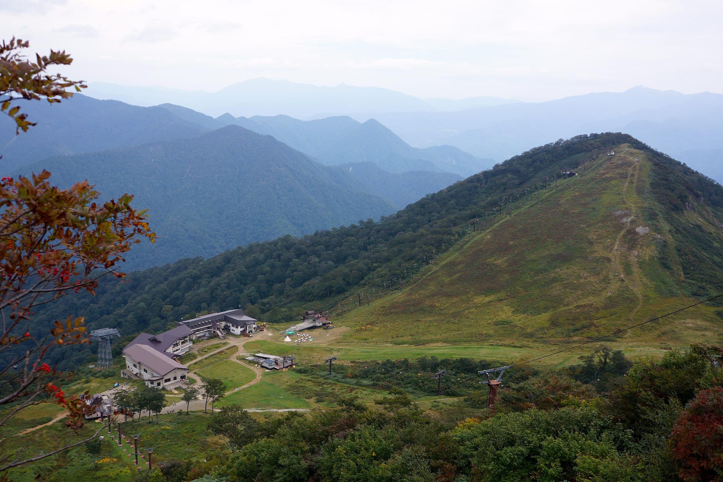 The Tenjindaira plateau and its ropeway station spread below a green ridge in September