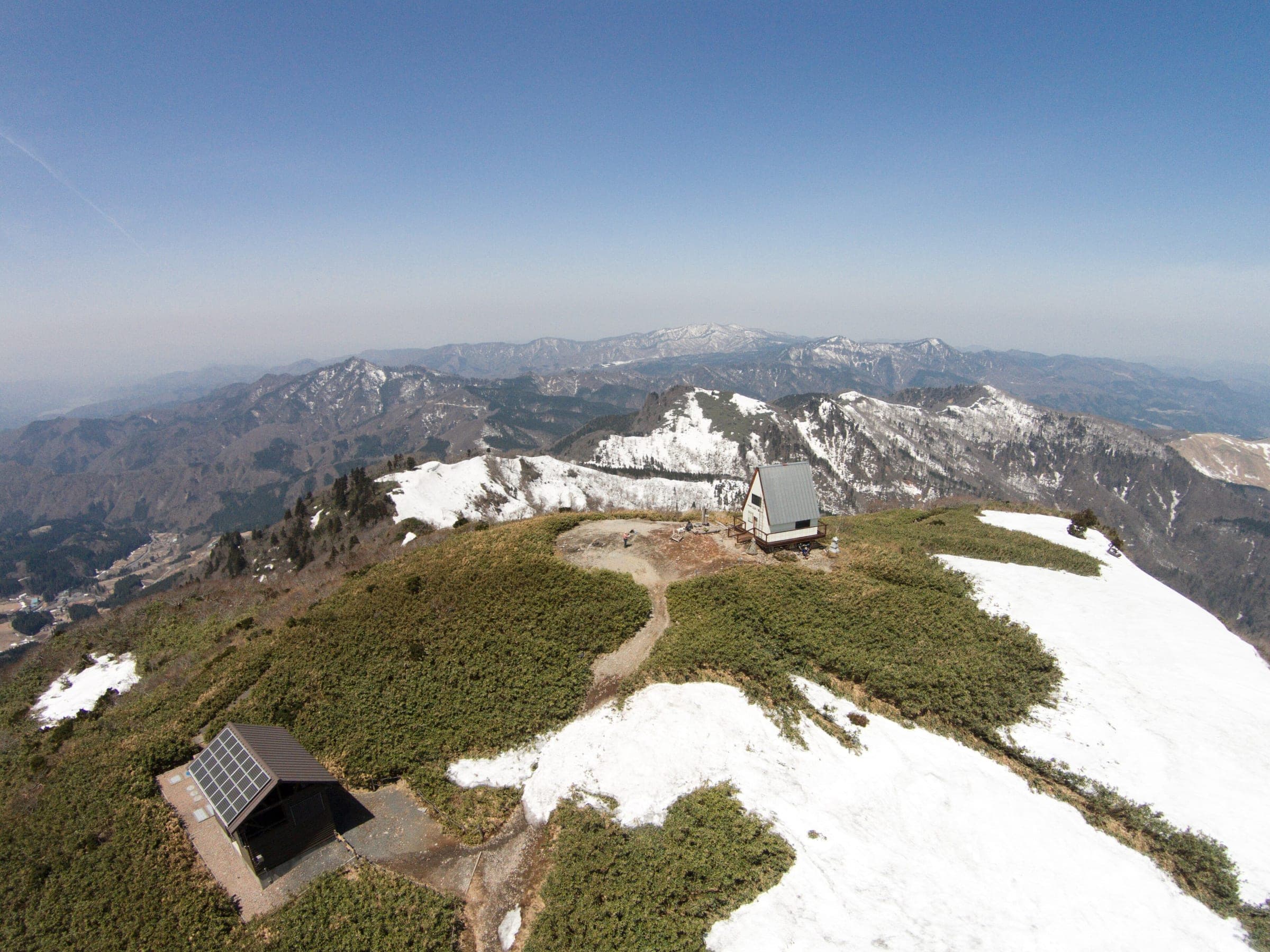 Late snow patches cling to the summit of Mount Hyonosen beside its mountain hut in April