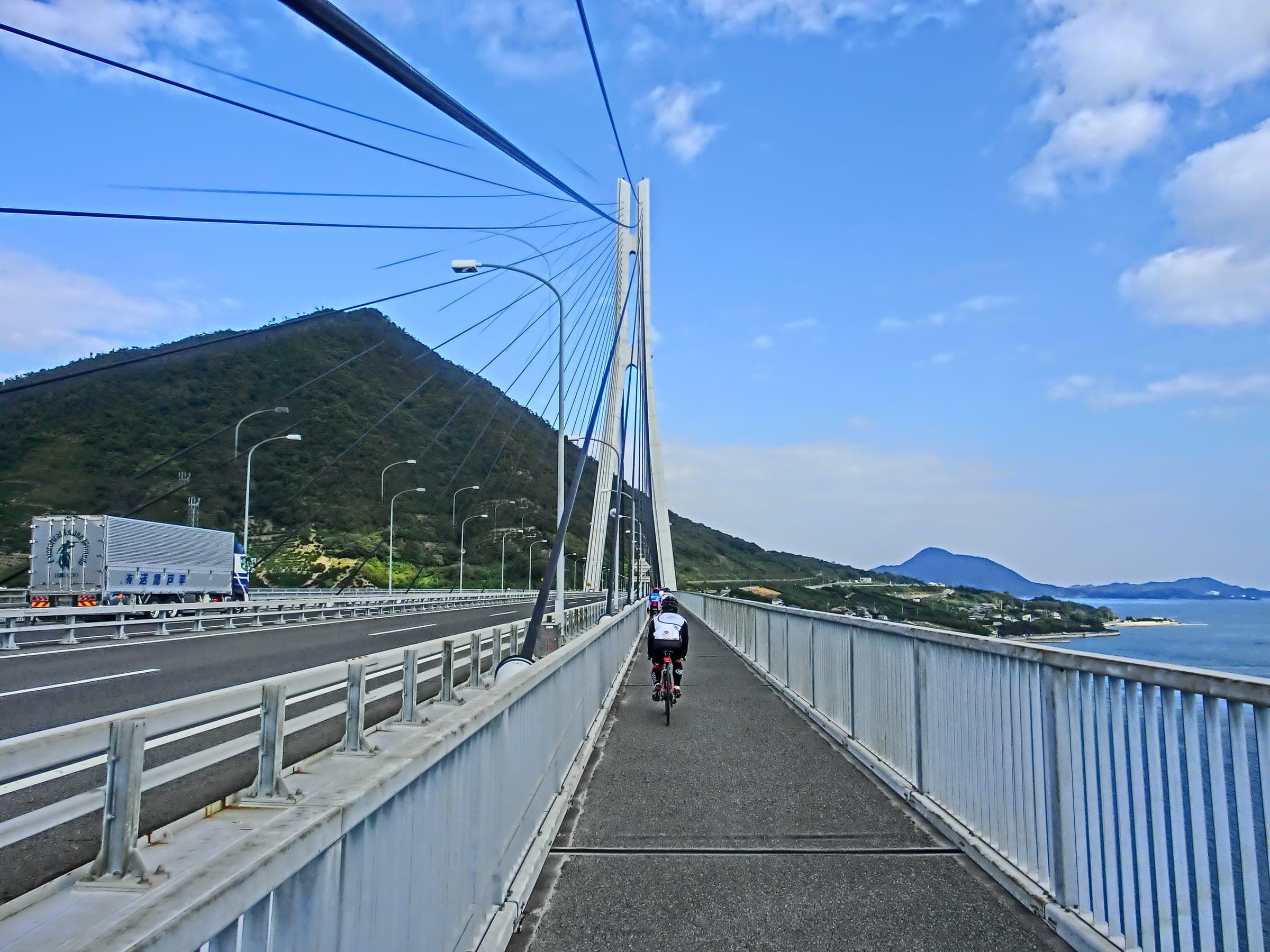 A rider crosses the Tatara Bridge bike lane from Omishima toward Ikuchijima in October