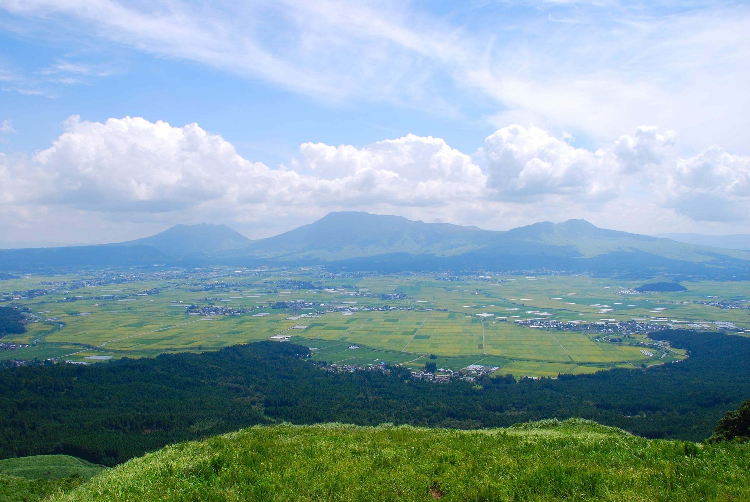 From Daikanbo you look across the farmland of the caldera floor to the five peaks of Mount Aso.