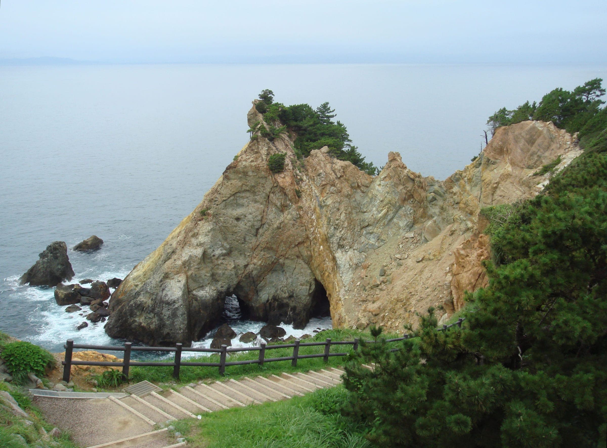 Golden rock walls of Cape Koganezaki drop into the sea on the west Izu coast near Dogashima.