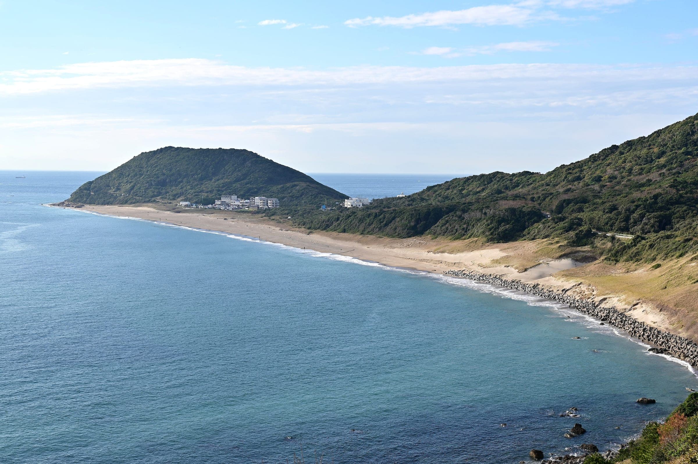 Koijigahama beach curves toward the green hill of Cape Irago at the tip of the Atsumi Peninsula