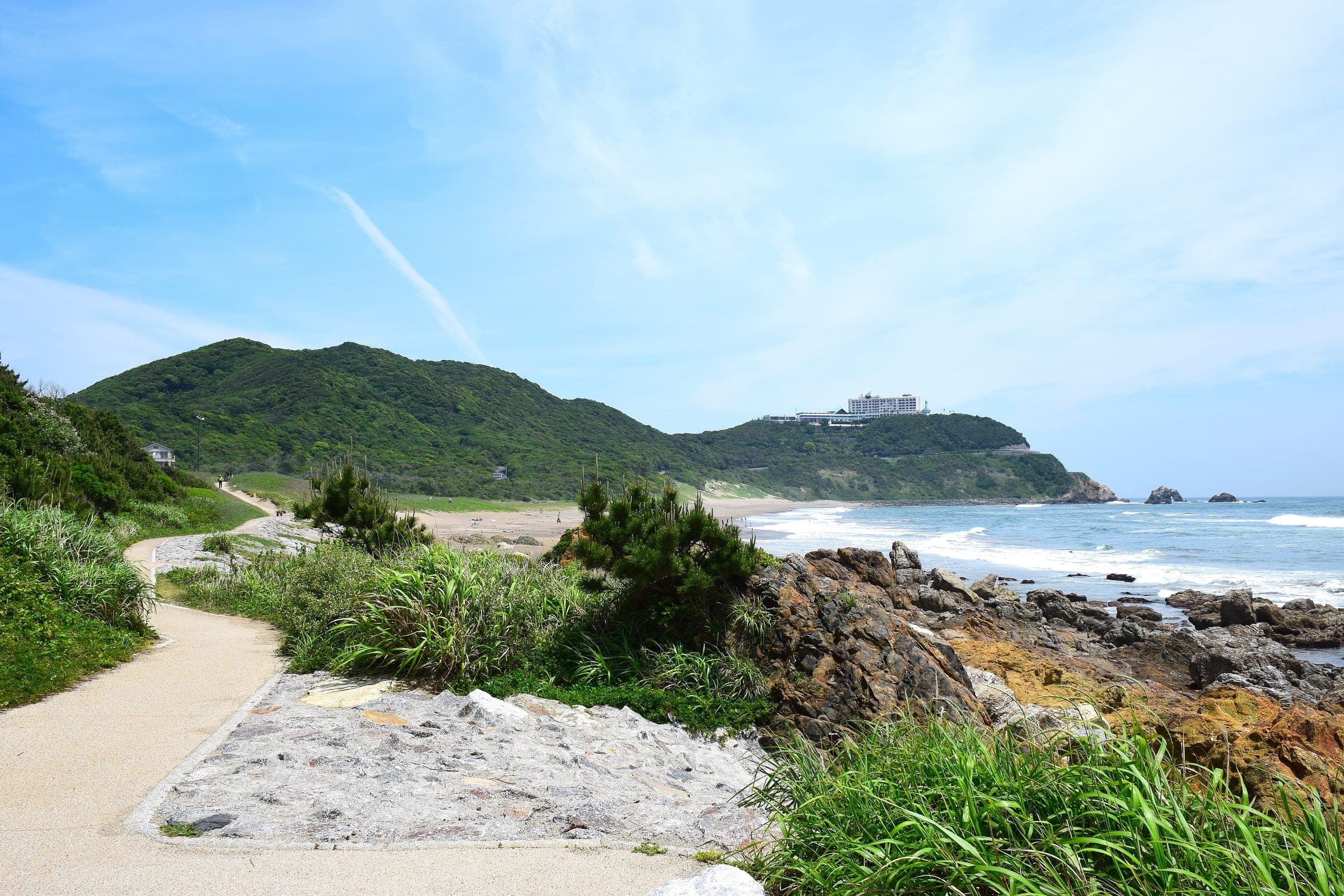 A paved path follows the rocky Pacific shore at Cape Irago in May
