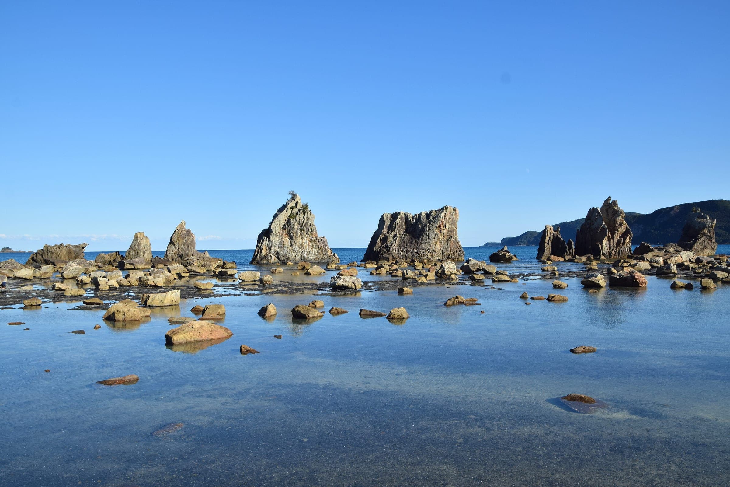 The Hashiguiiwa rock pillars march out from the shore at Kushimoto under a clear November sky