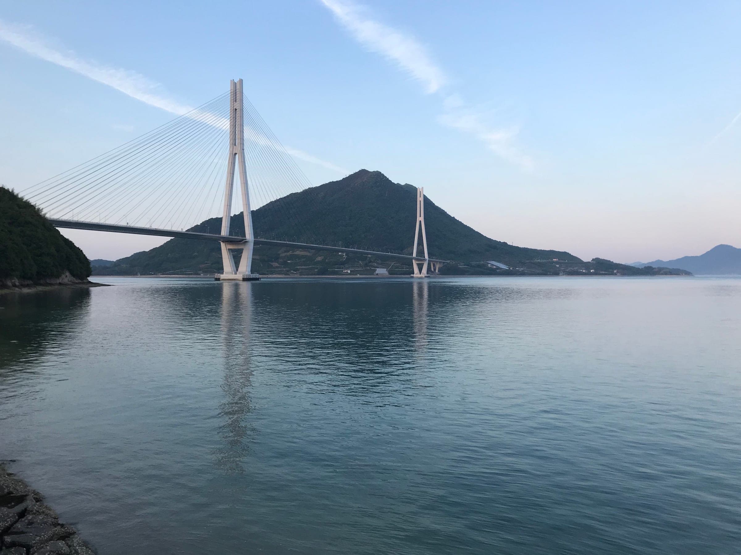 The Tatara Bridge spans calm water from Omishima toward Mount Kannonyama on Ikuchijima.