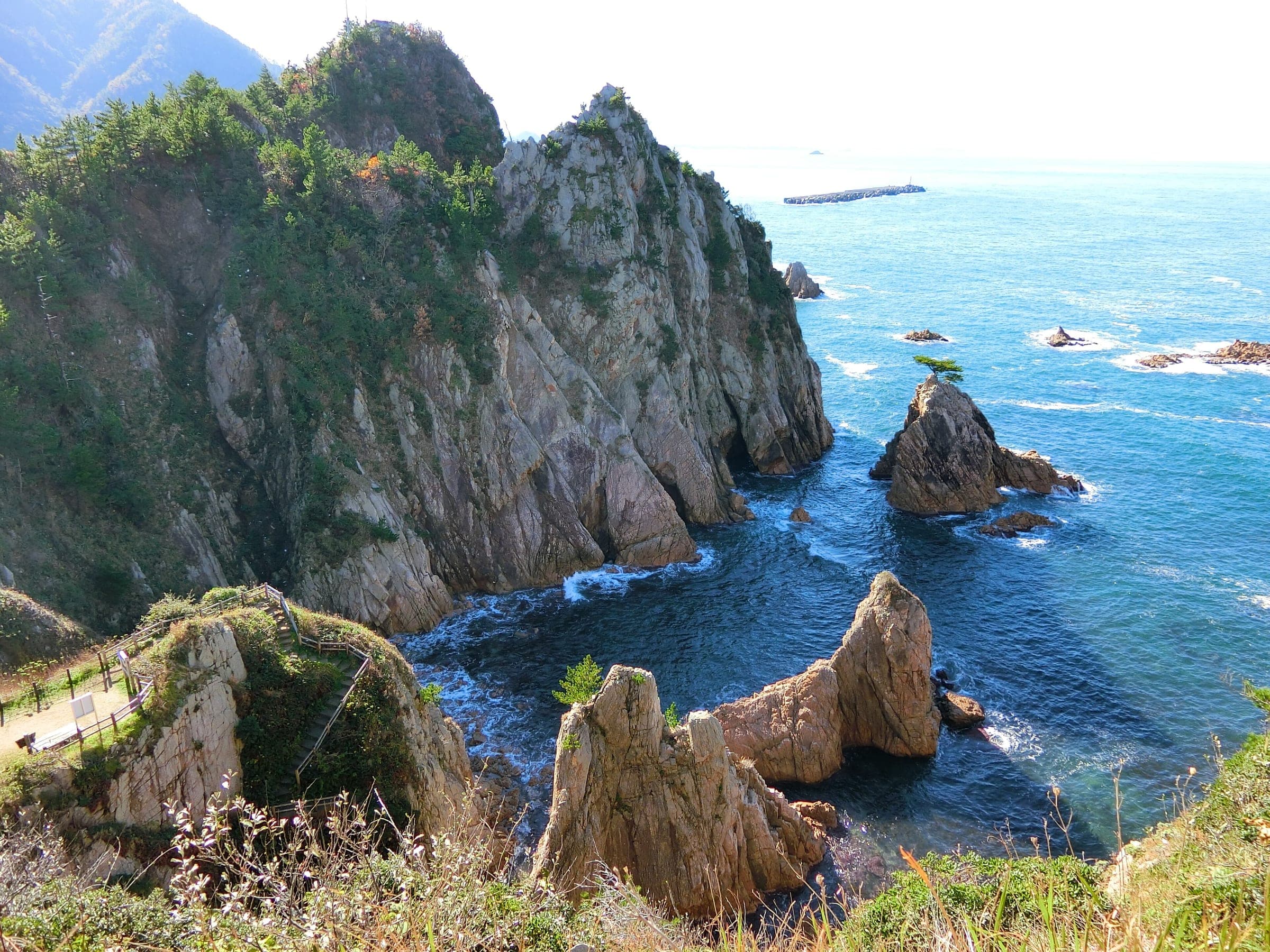 Pine-topped granite cliffs and sea stacks line the Uradome Coast east of Tottori