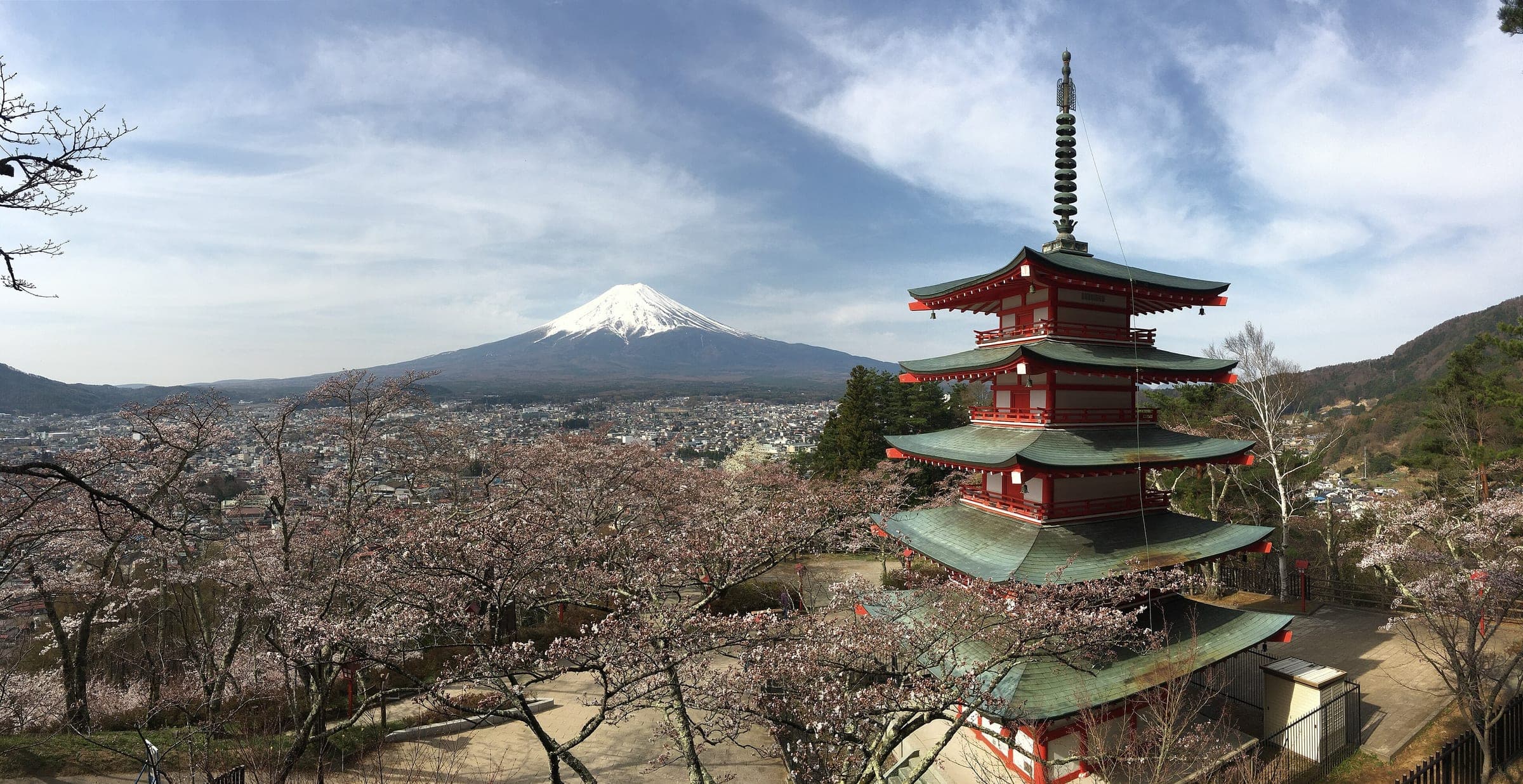 The five-storey Chureito Pagoda at Arakurayama Sengen Park faces snow-capped Mt. Fuji over Fujiyoshida in early spring.