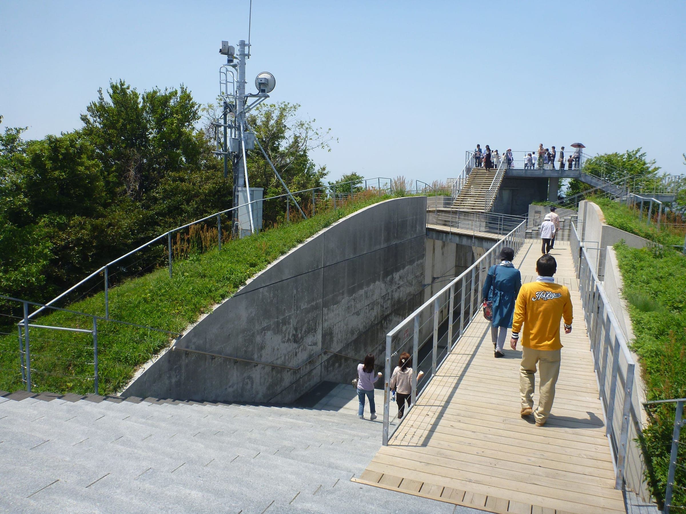 Visitors climb the sunken concrete walkway to the Kirosan observation deck on Oshima