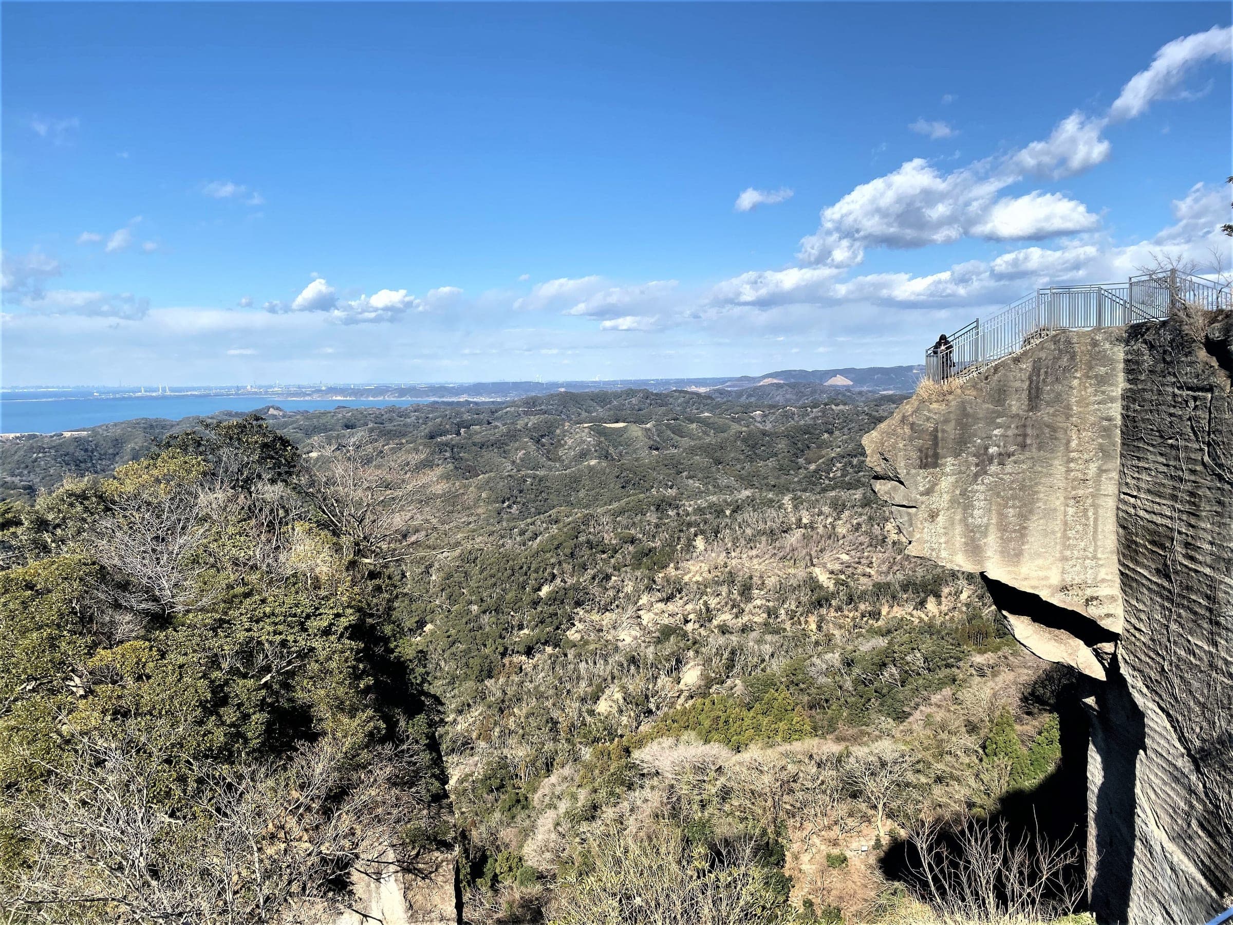 The Jigoku Nozoki ledge juts from a quarried cliff on Mt. Nokogiri above the forested Boso hills and Tokyo Bay.