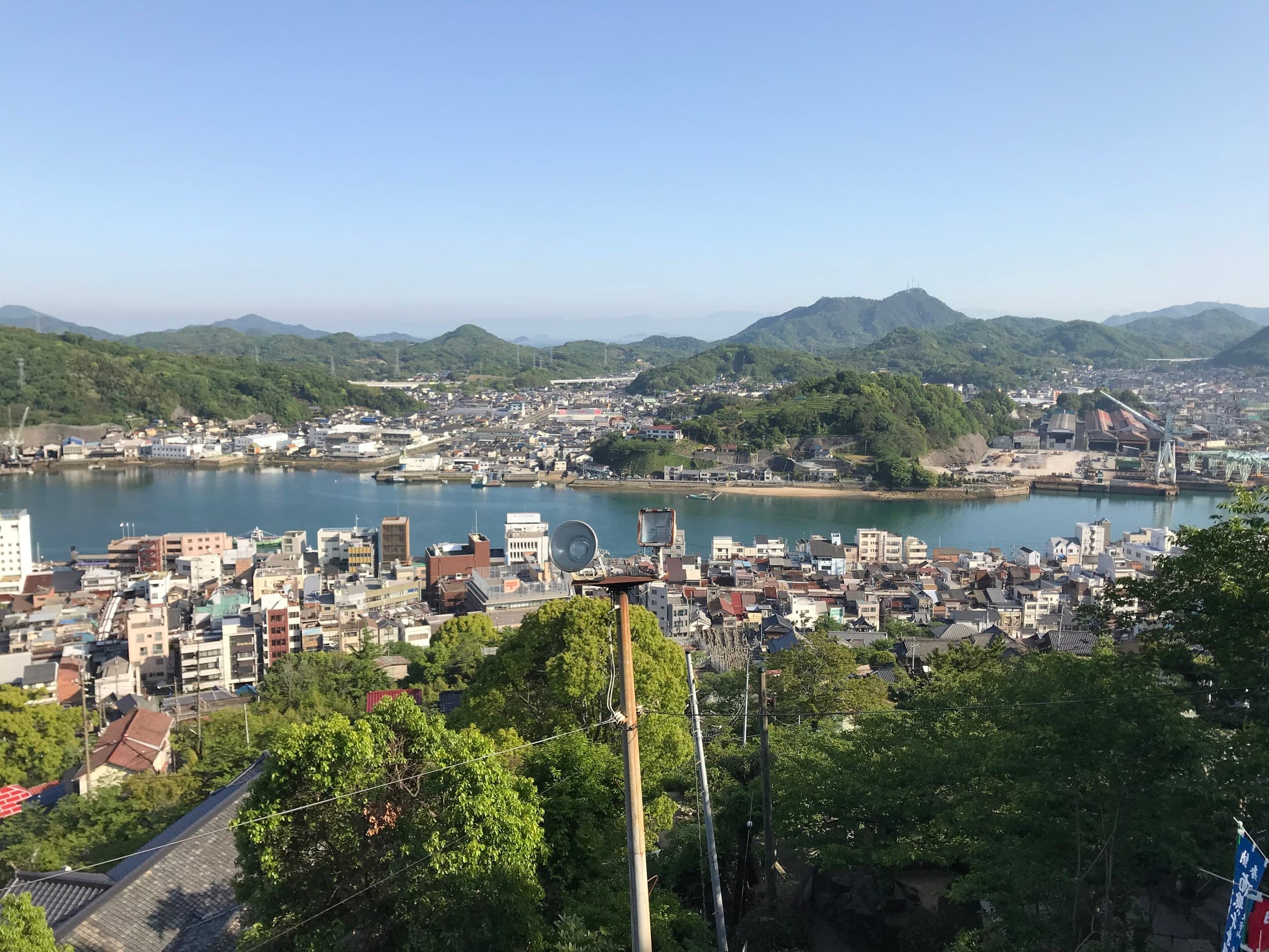 Onomichi's rooftops run down to the channel and Mukaishima, seen from the main hall of Senkoji.