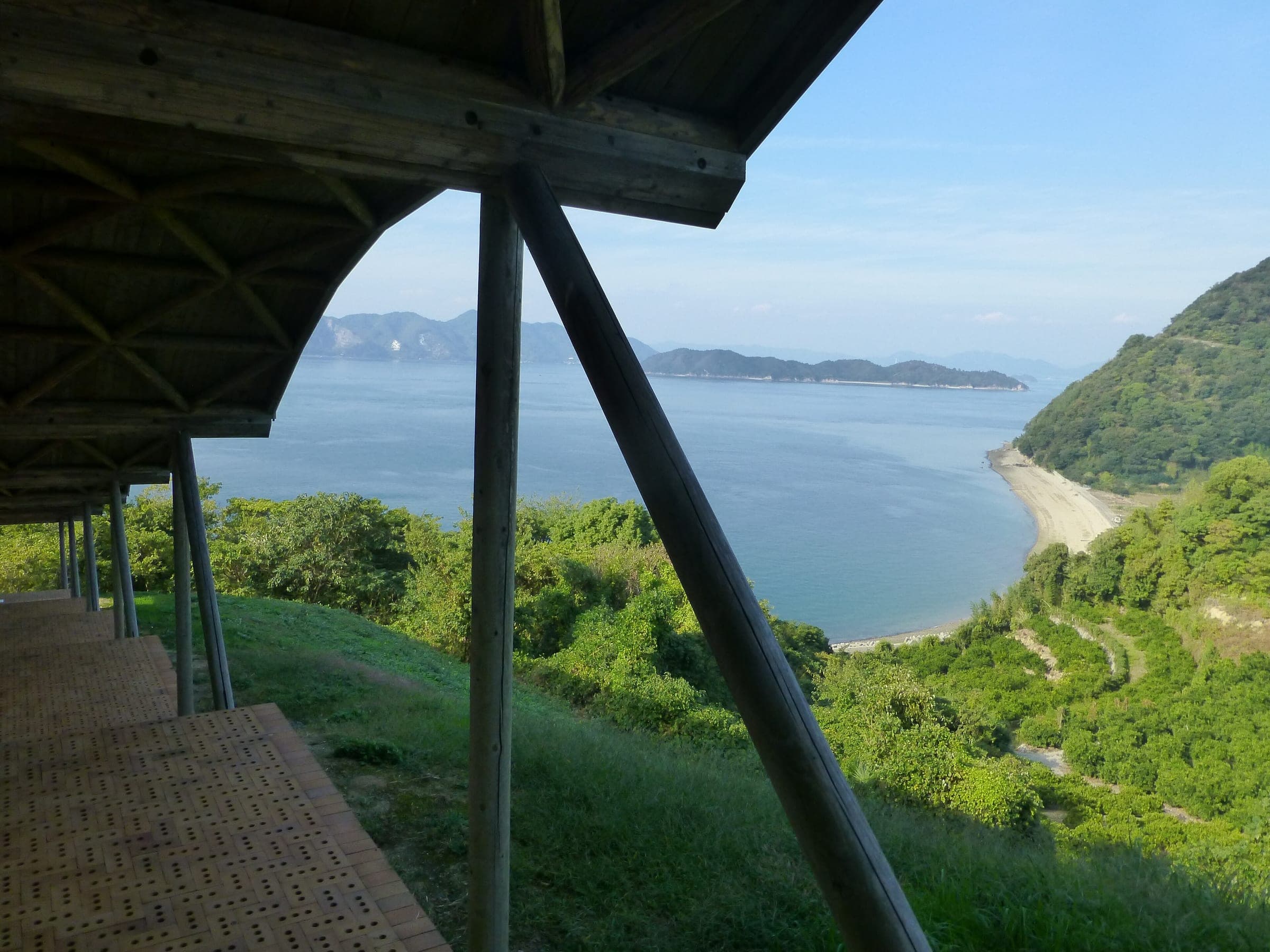 The timber terrace of Tokoro Museum Omishima looks down to a sandy cove and the inland sea.