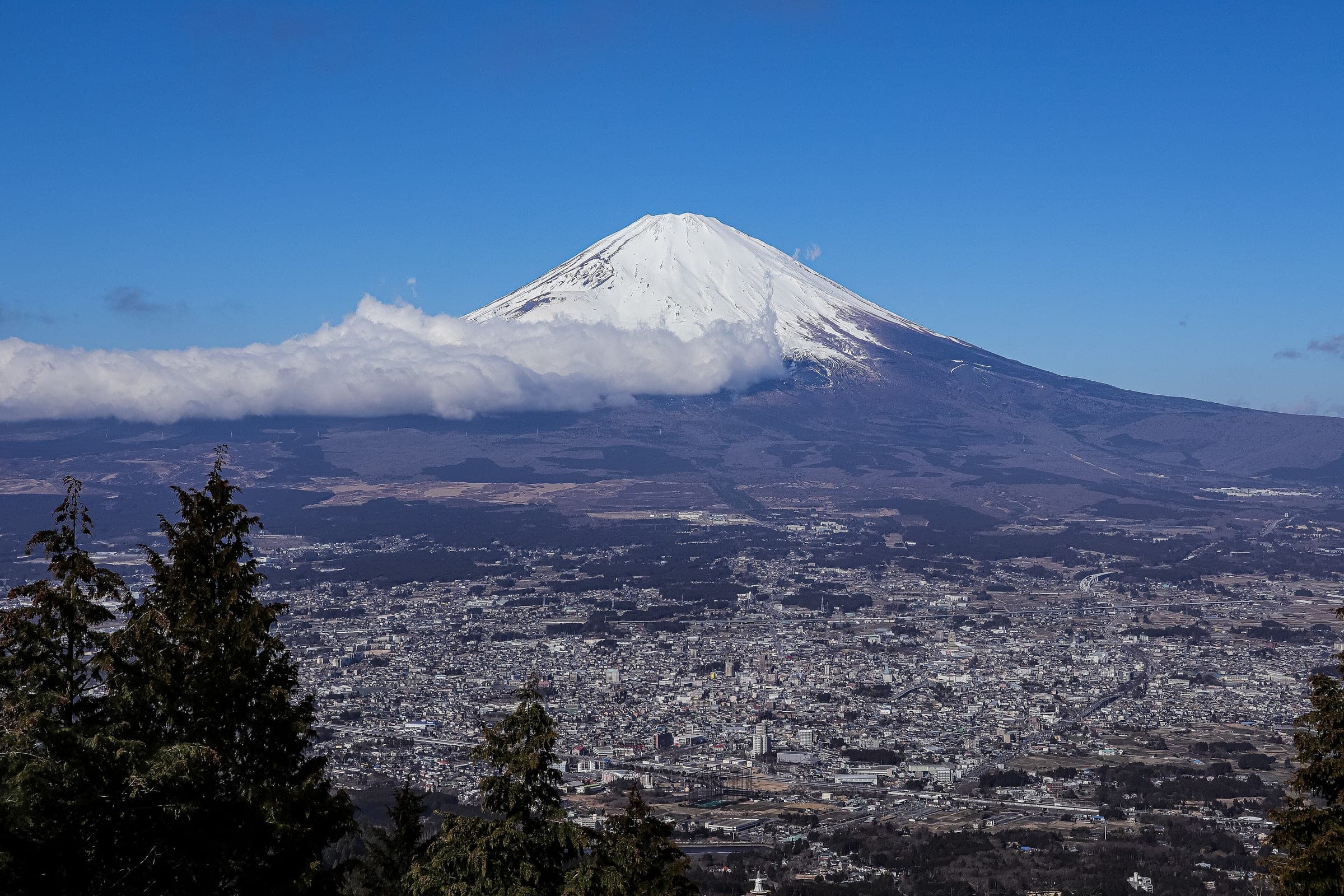 Snow-capped Mt. Fuji towers over the streets of Gotemba in this February view from Otome Pass.