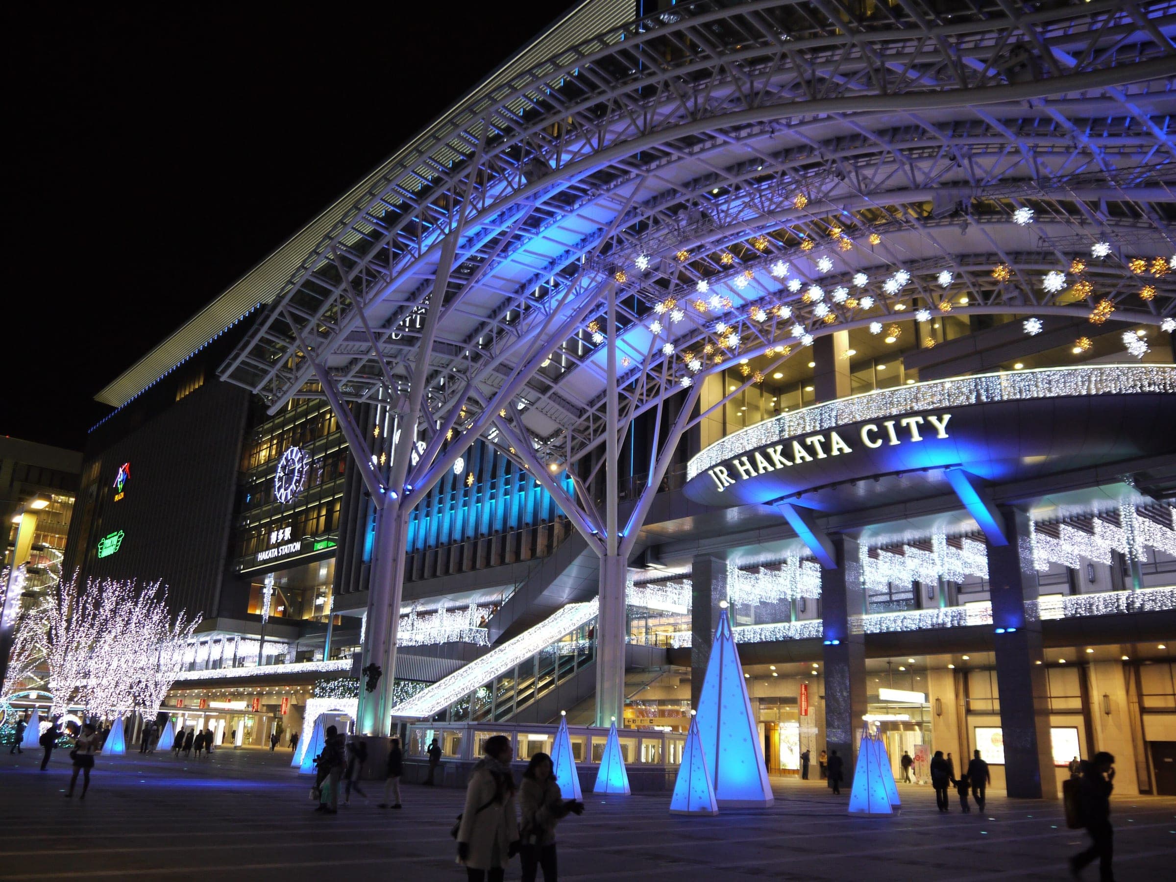Blue and white winter lights fill the steel canopy outside JR Hakata City at Hakata Station.